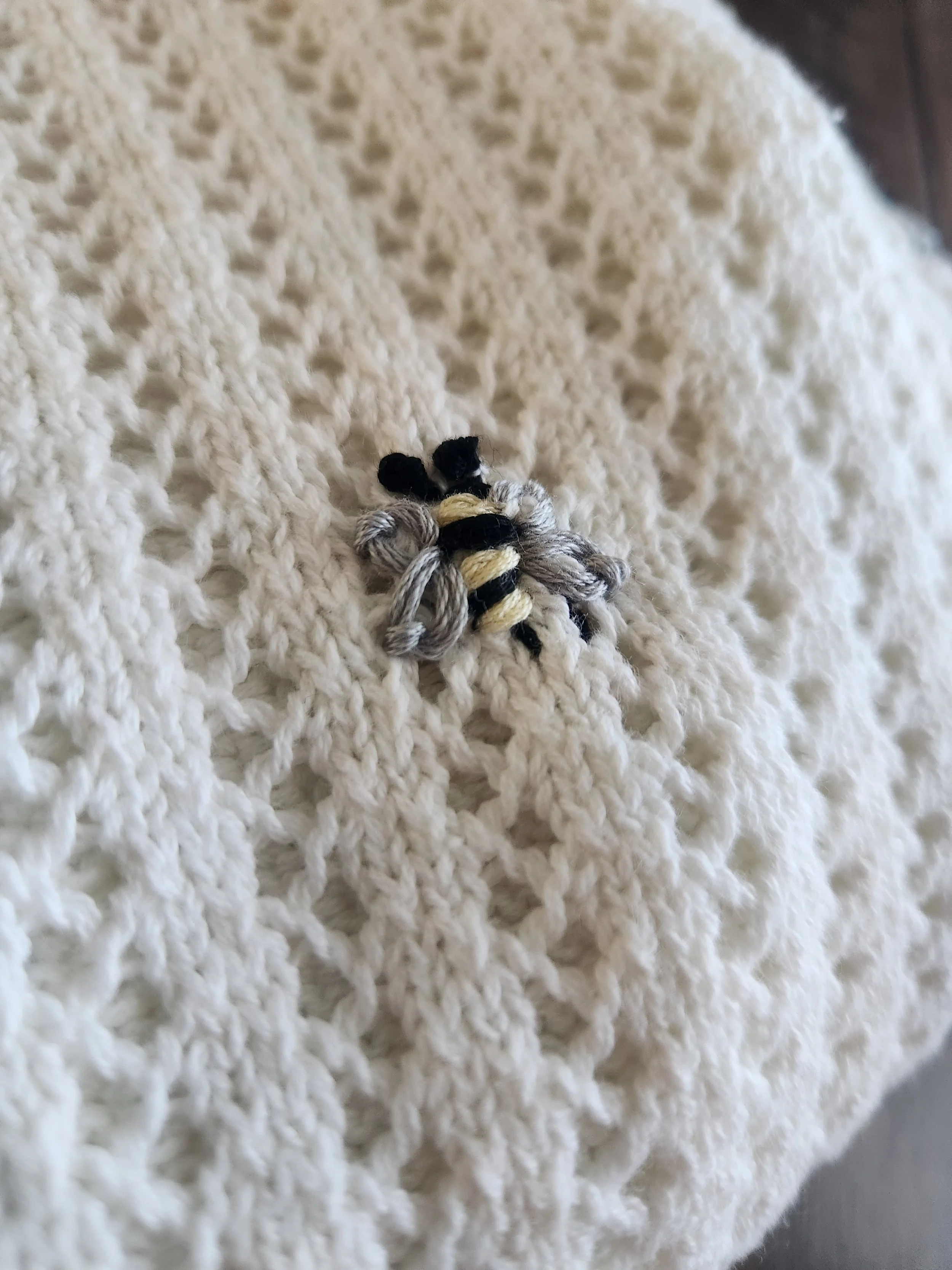 Of Character embroidered bee detail on upcycled sweater.jpg