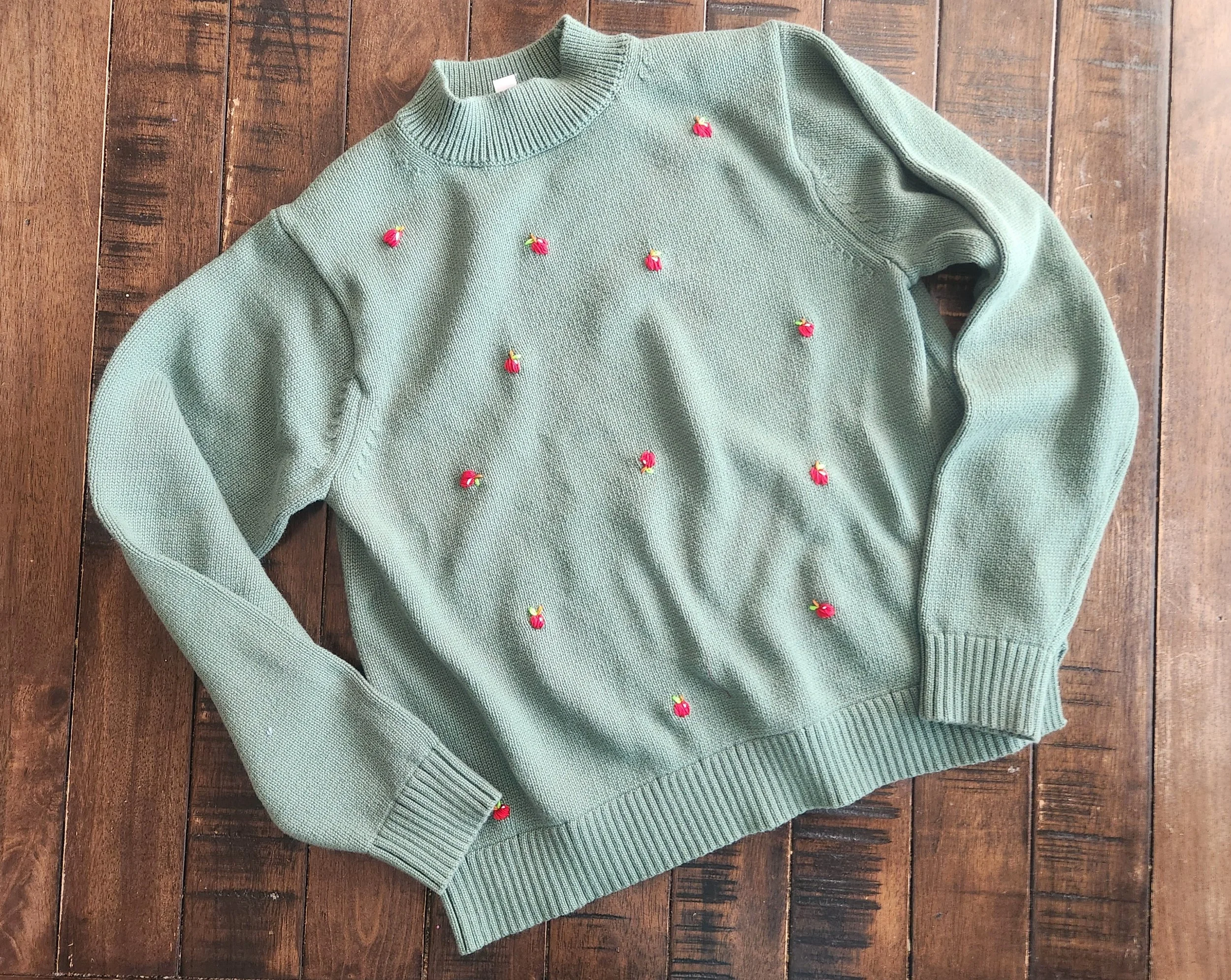 Of Character embroidered Apples on upcycled sweater.jpg