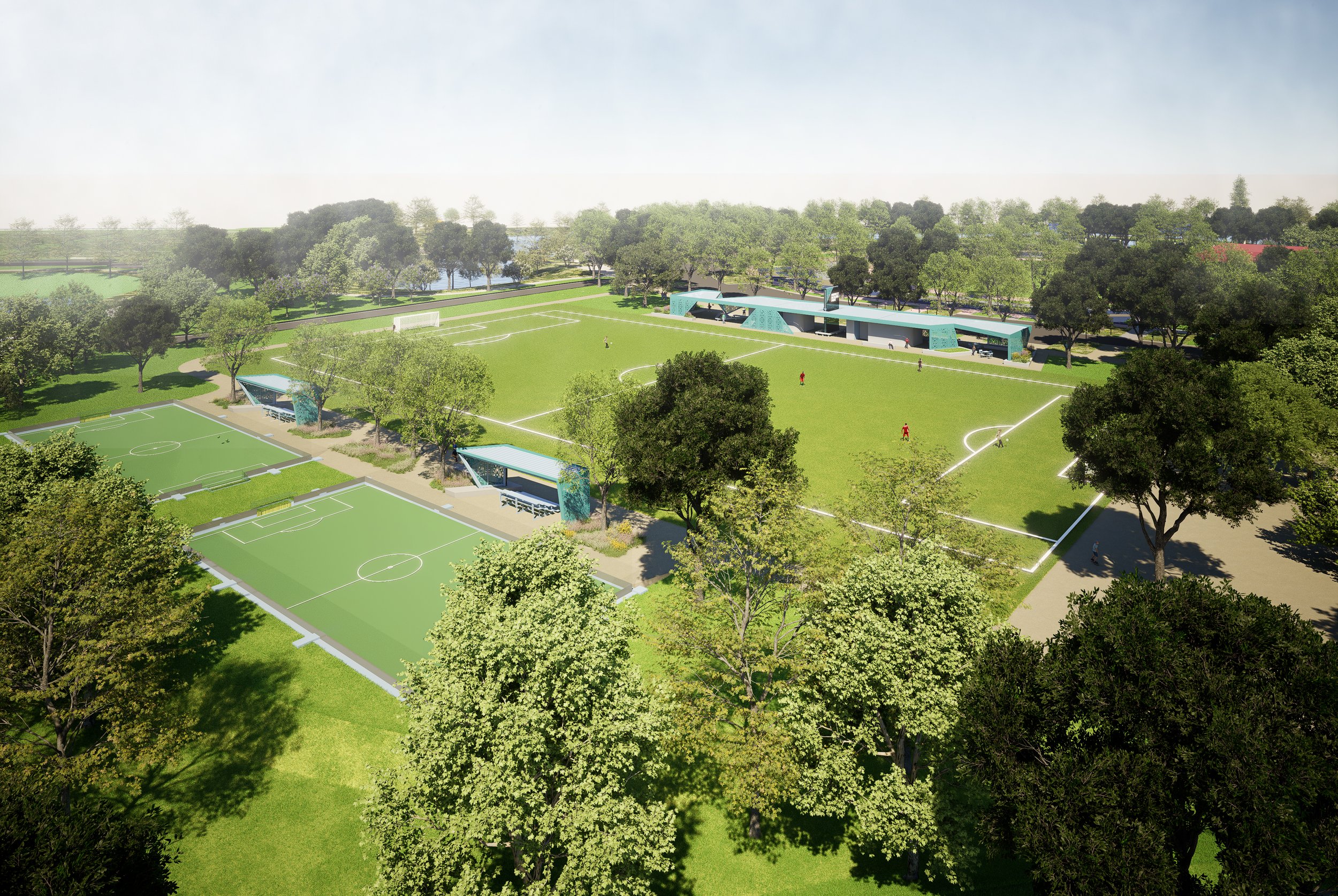 An aerial view of Burnett Bayland Park's future plans with several small soccer fields, walking paths, numerous trees, and a modern building with a blue roof.
