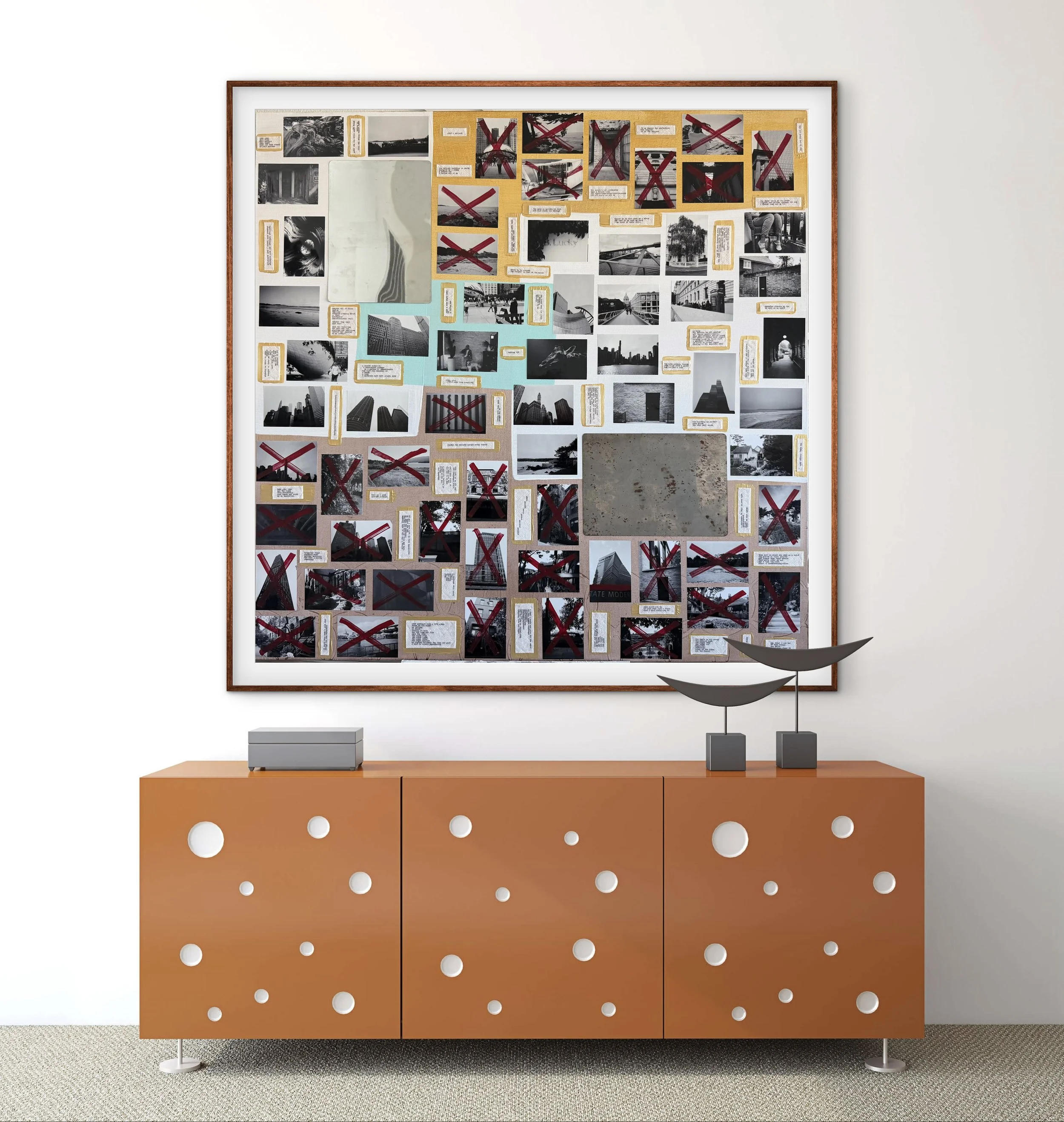 A wooden sideboard with a light wood top and orange lower cabinet with white circular holes, a white wall in the background, and a decor piece with multiple photos and notes, some marked with red crosses, attached to a large white frame.