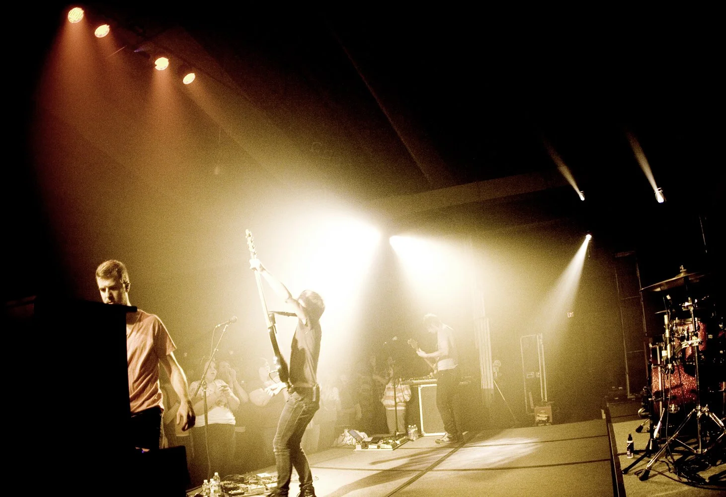 Musicians performing on stage with bright stage lights