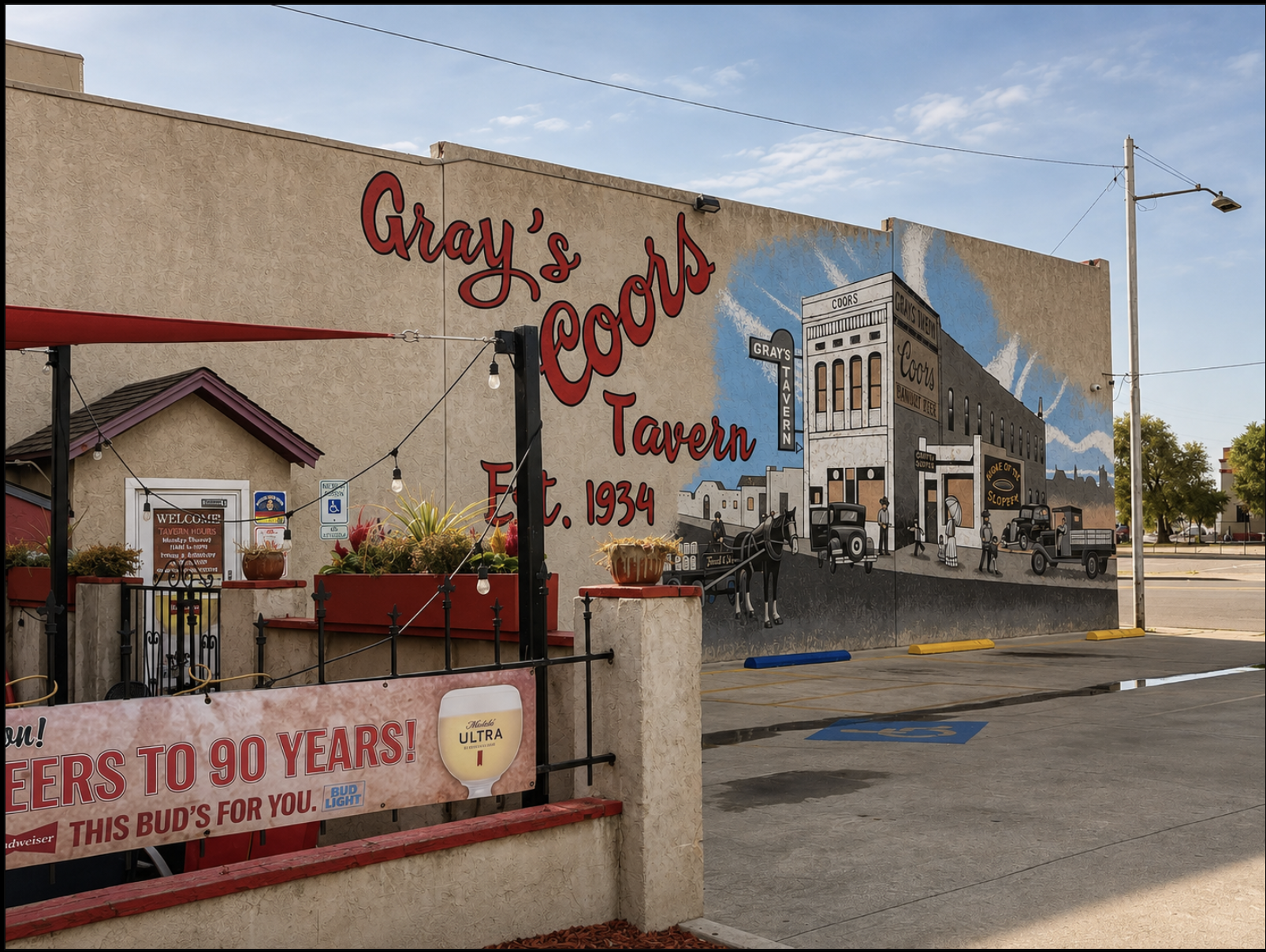 A mural on the side of a building depicts a historic scene, signifying Gray's Tavern established in 1934. The mural features old-fashioned cars, people in period clothing, and a building labeled "Codors". The building exterior has vintage advertiseme