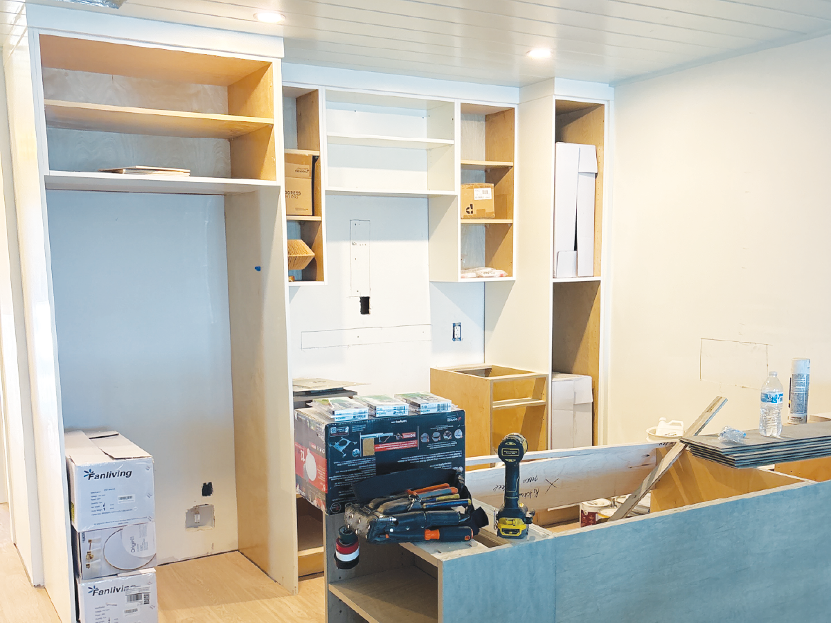 Kitchen renovation in progress with custom cabinetry being installed during construction.