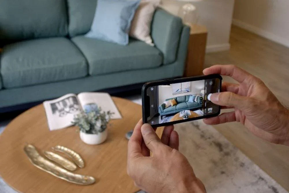 Photographing home furnishings and decor to prepare items for resale on Facebook Marketplace during a renovation project.