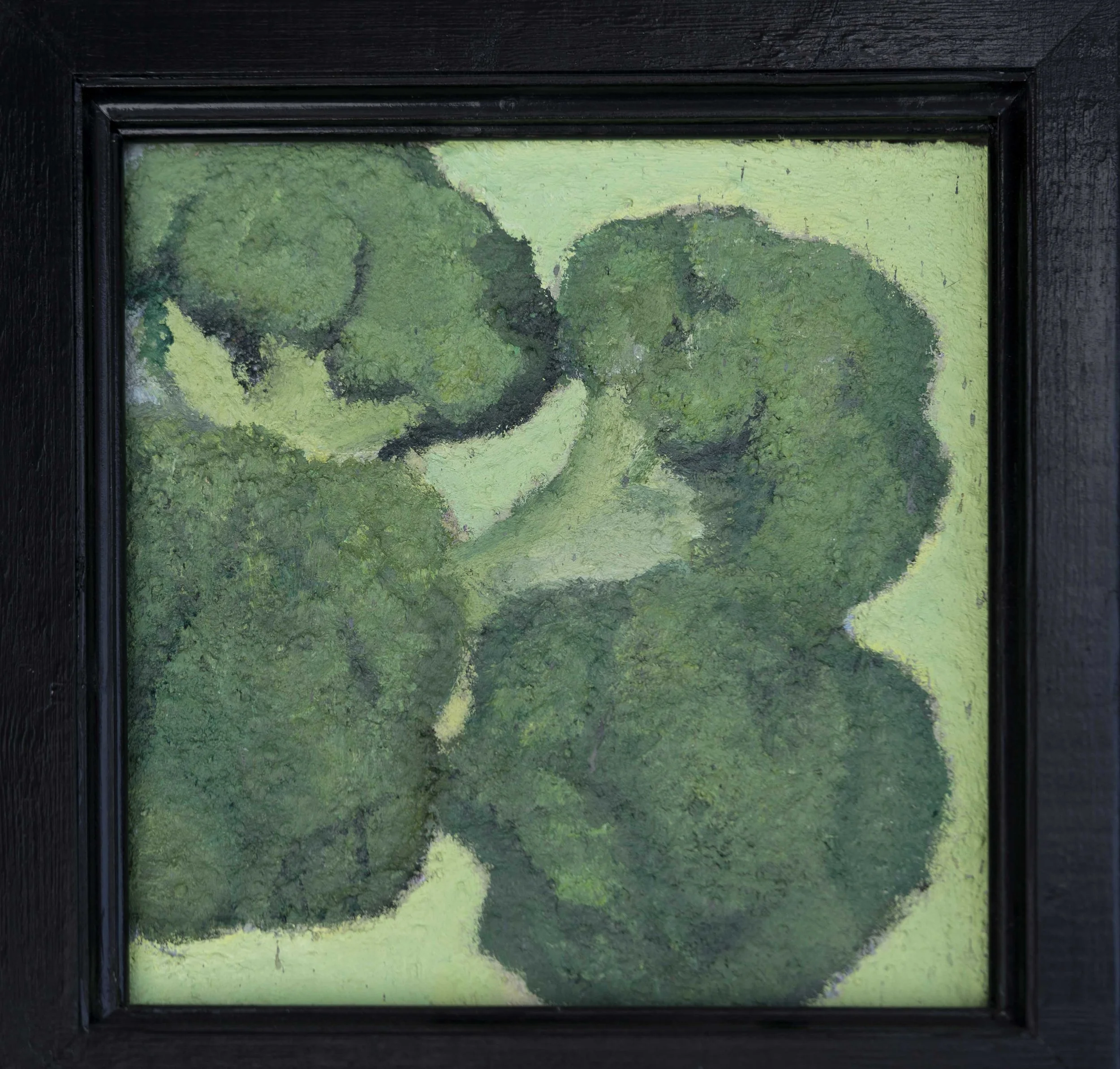 A framed painting of broccoli on a green background.