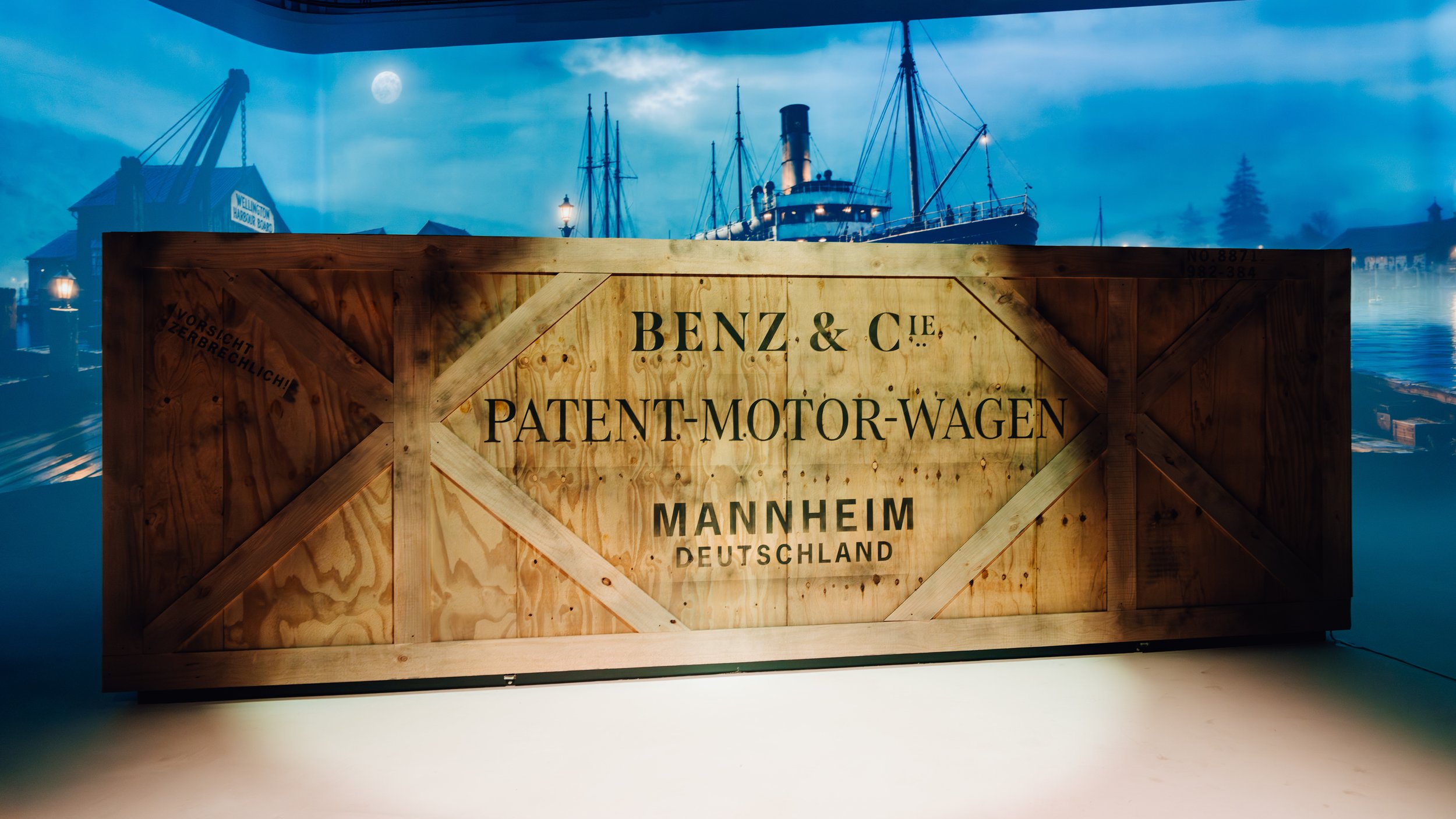Vintage "Benz & Cie" wooden crate branded with historic Mannheim shipping imagery.