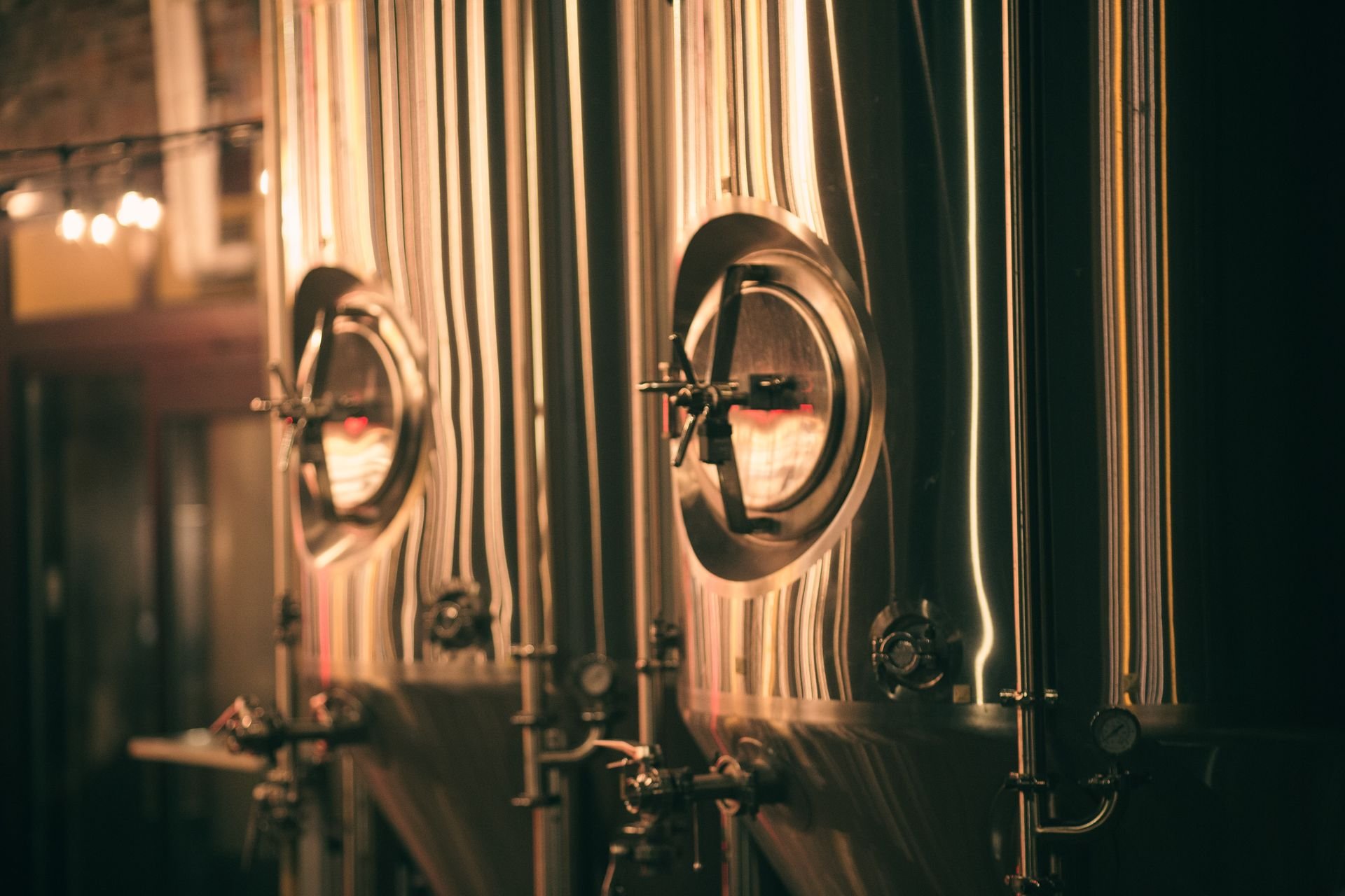 close up of brewery tanks in warm light