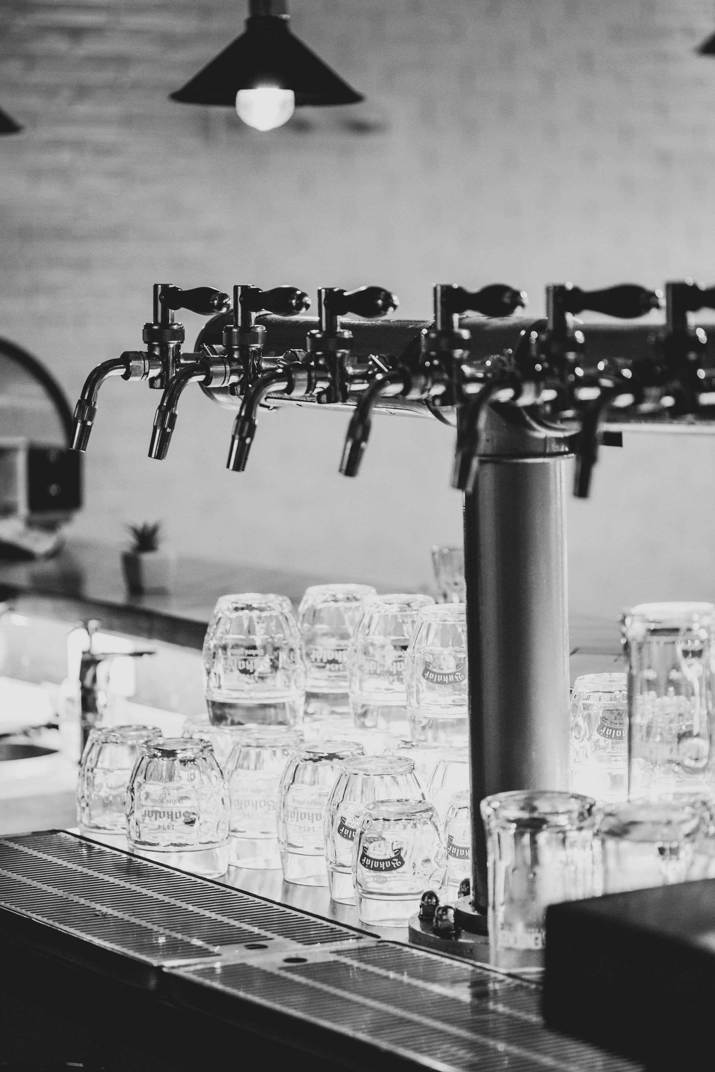 black and white beer taps with glasses and bartop