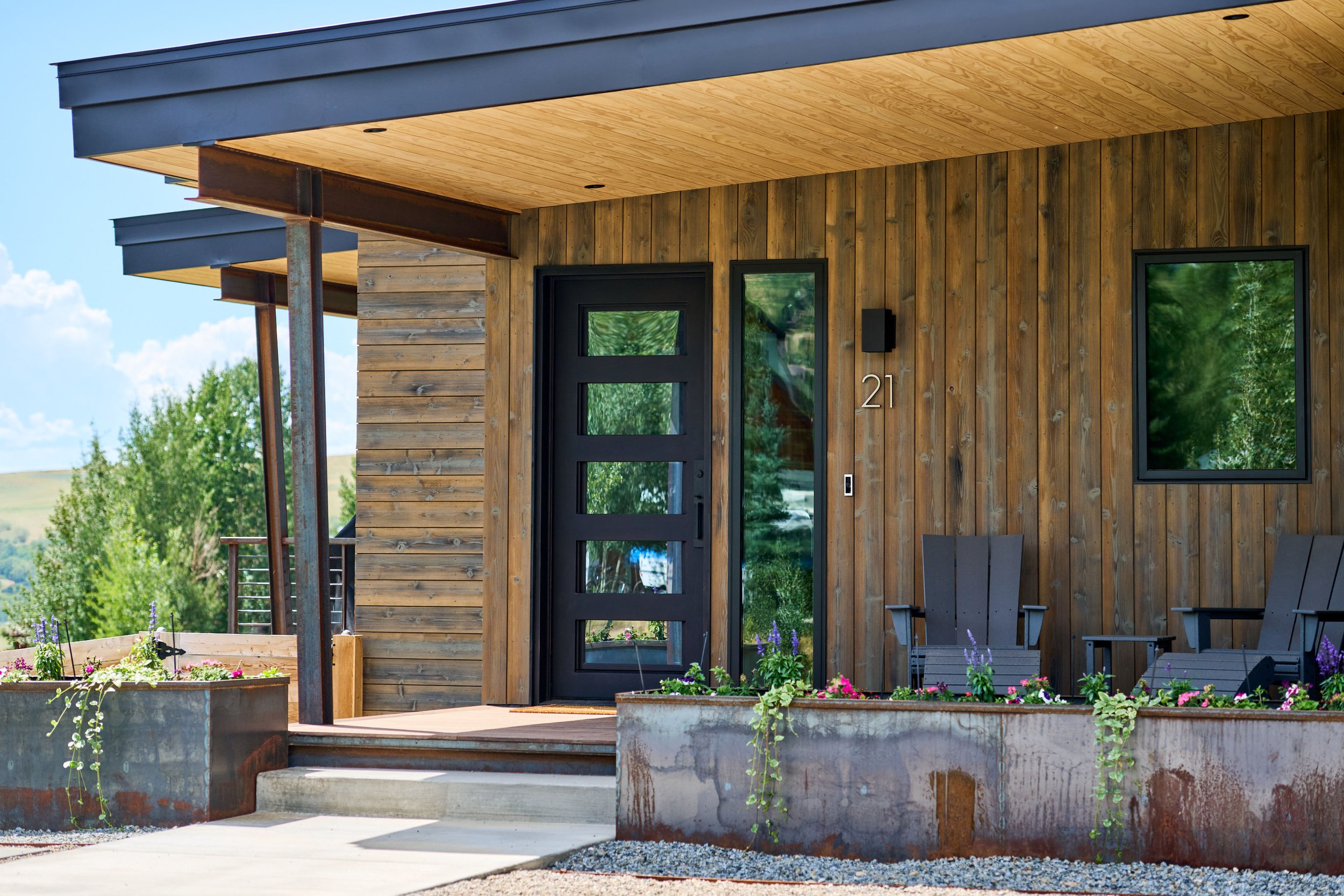 Stephenson Place covered entry with vertical wood siding, Crested Butte, Colorado