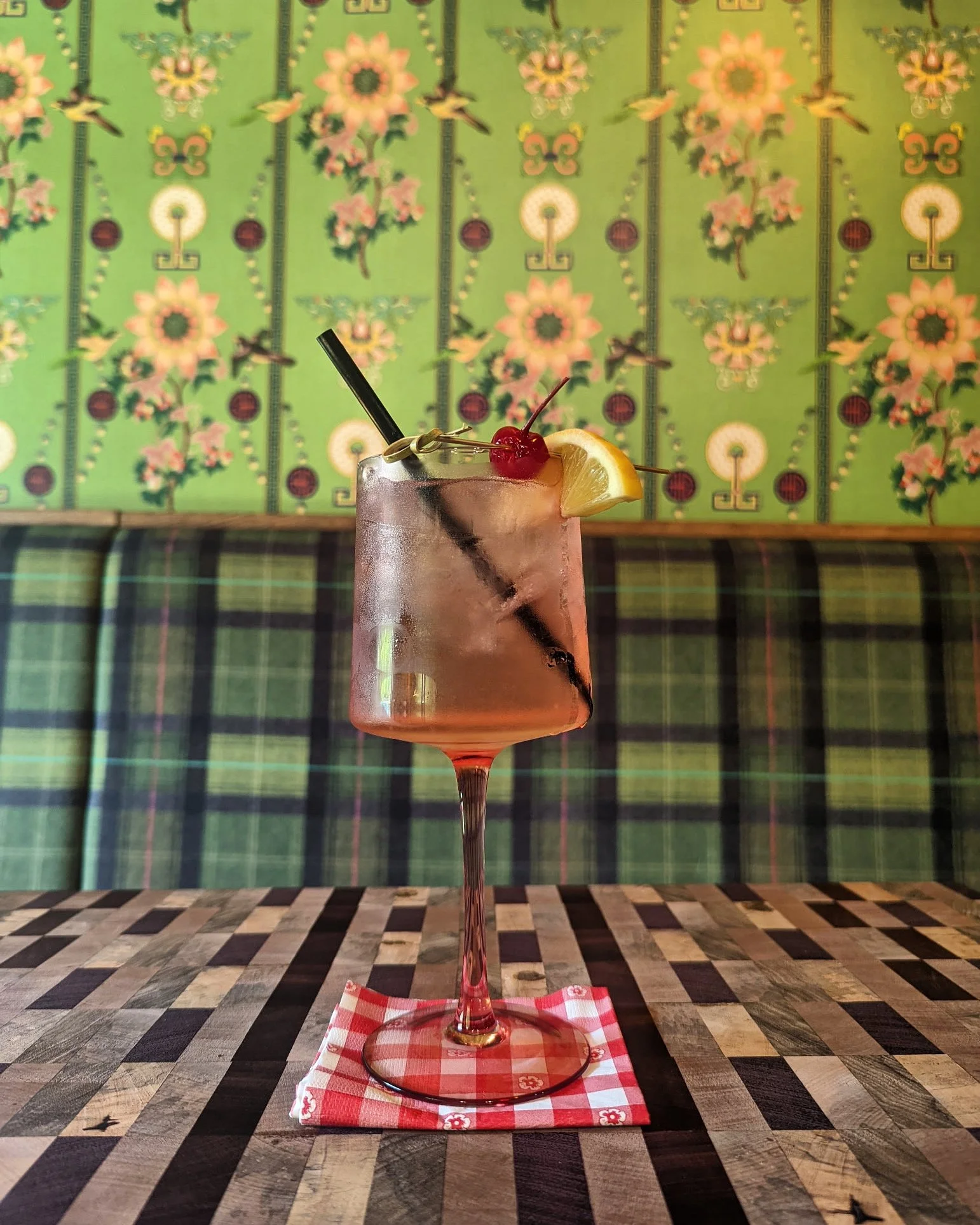 vanilla vodka spritzer in a tall pink glass