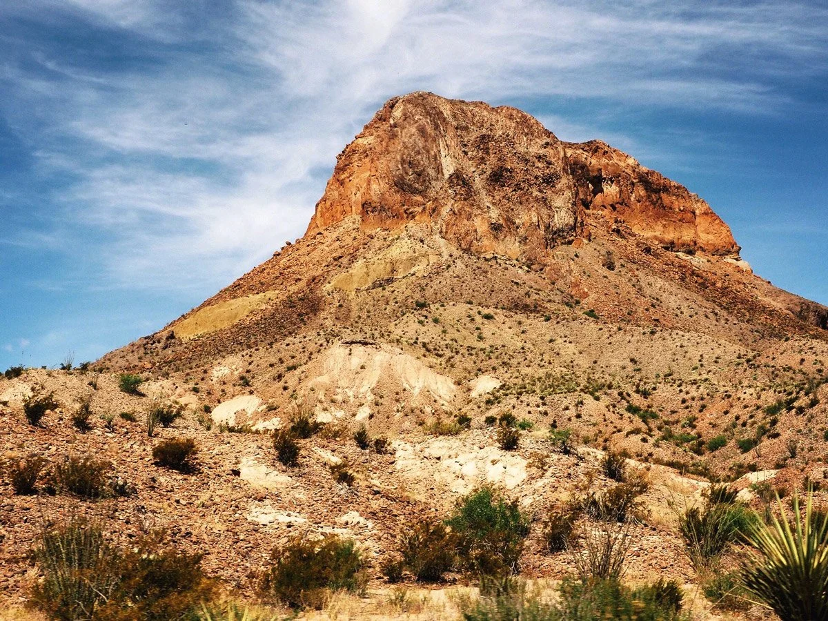 steep mountain with red rocks surrounded by yucca plants representing scalable growth