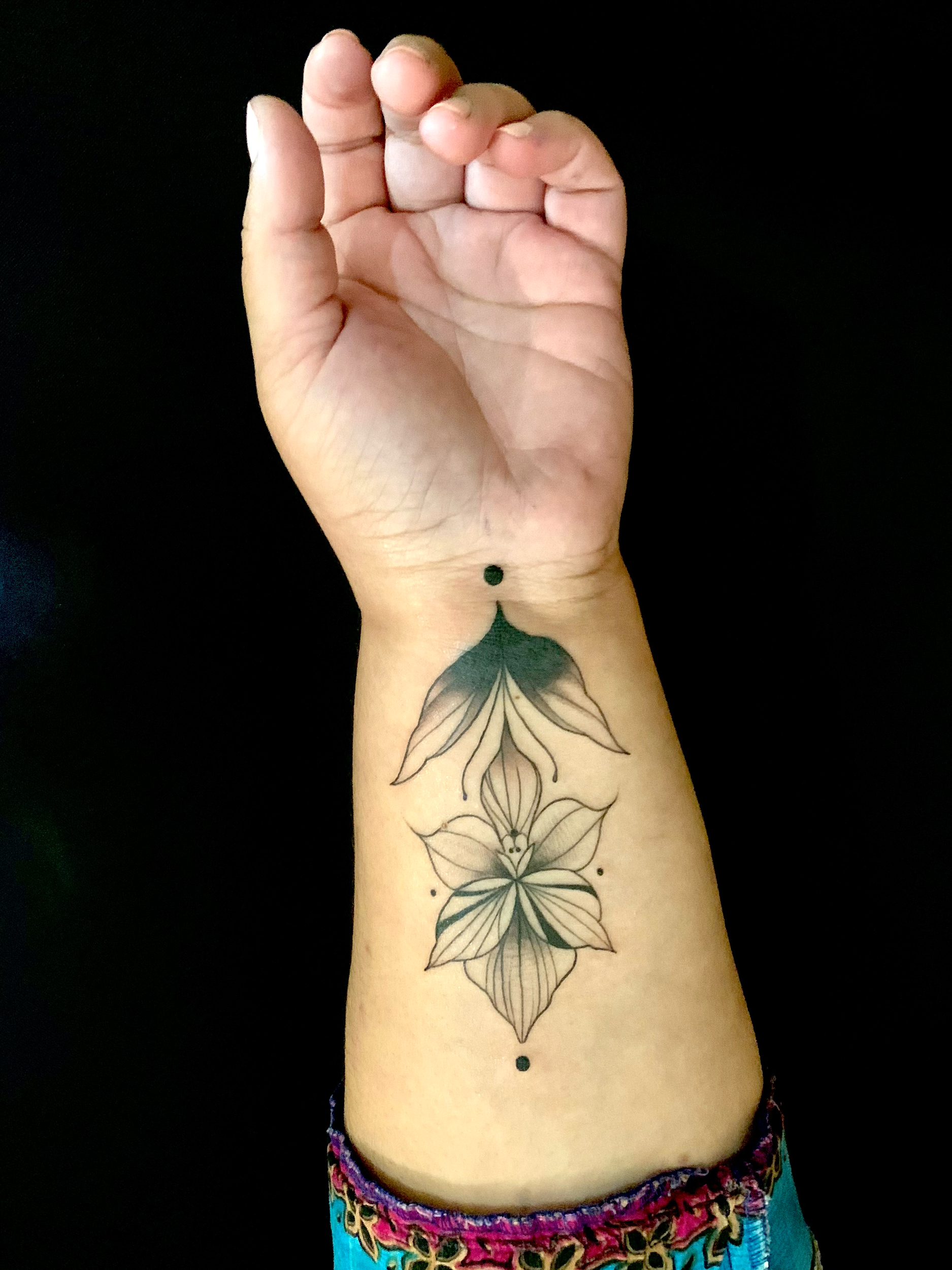 Ornamental floral tattoo on the inner wrist