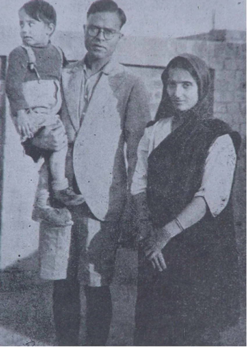 Black-and-white archival photograph of the Vohra family, c. 1928, showing two adults and a young child.