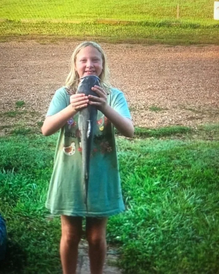 A young guest shows off her catch from the Tallahatchie River.