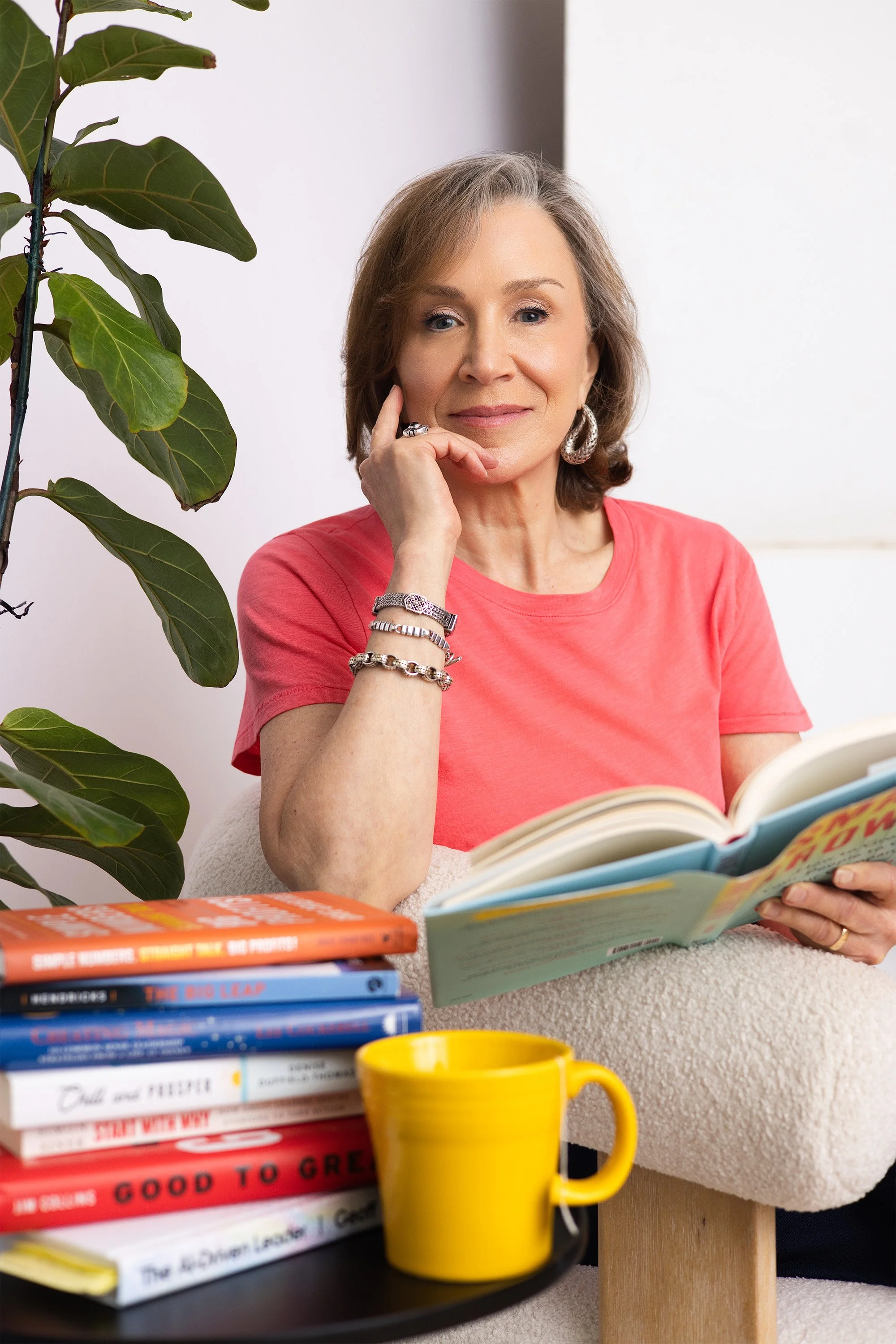 Studio business coach reading thoughtfully — reflecting the intentional, high-touch approach behind her membership program.