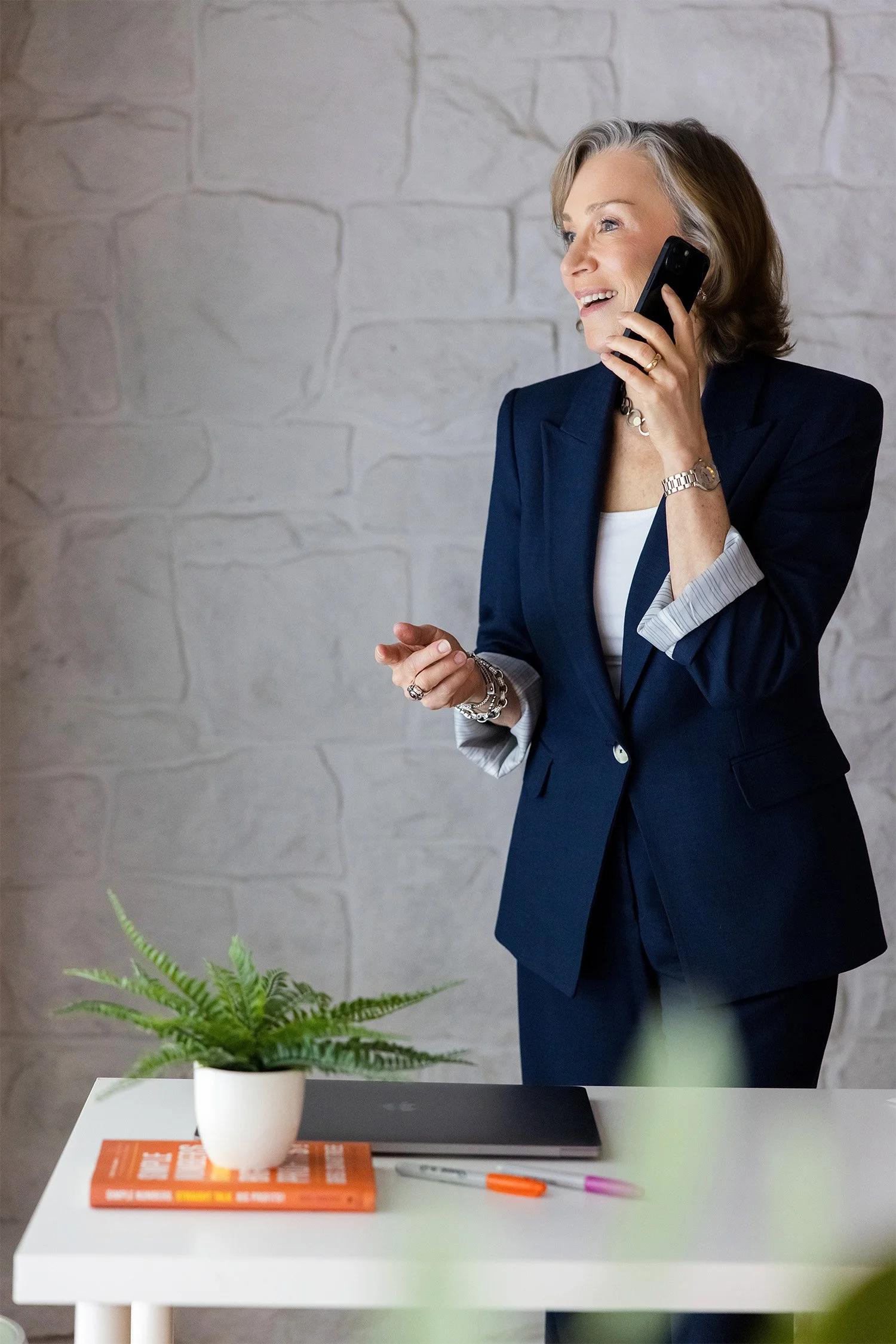 Business coach for studio owners on a call at her desk, preparing for a free Discovery Call.