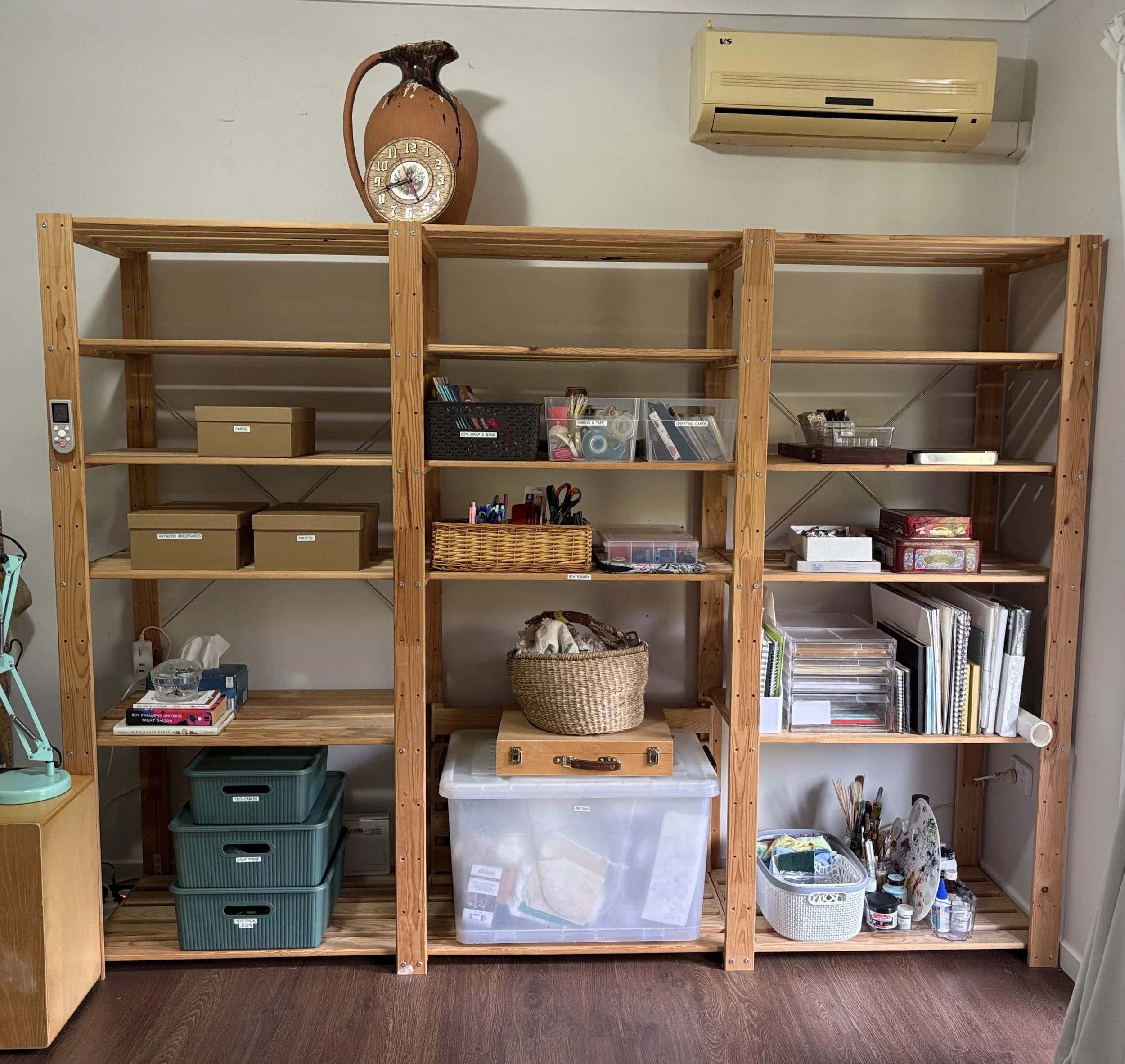Organised multipurpose storage shelves with art supplies, paperwork, utility and sentimental items sorted into clearly defined, easy-to-access categories.