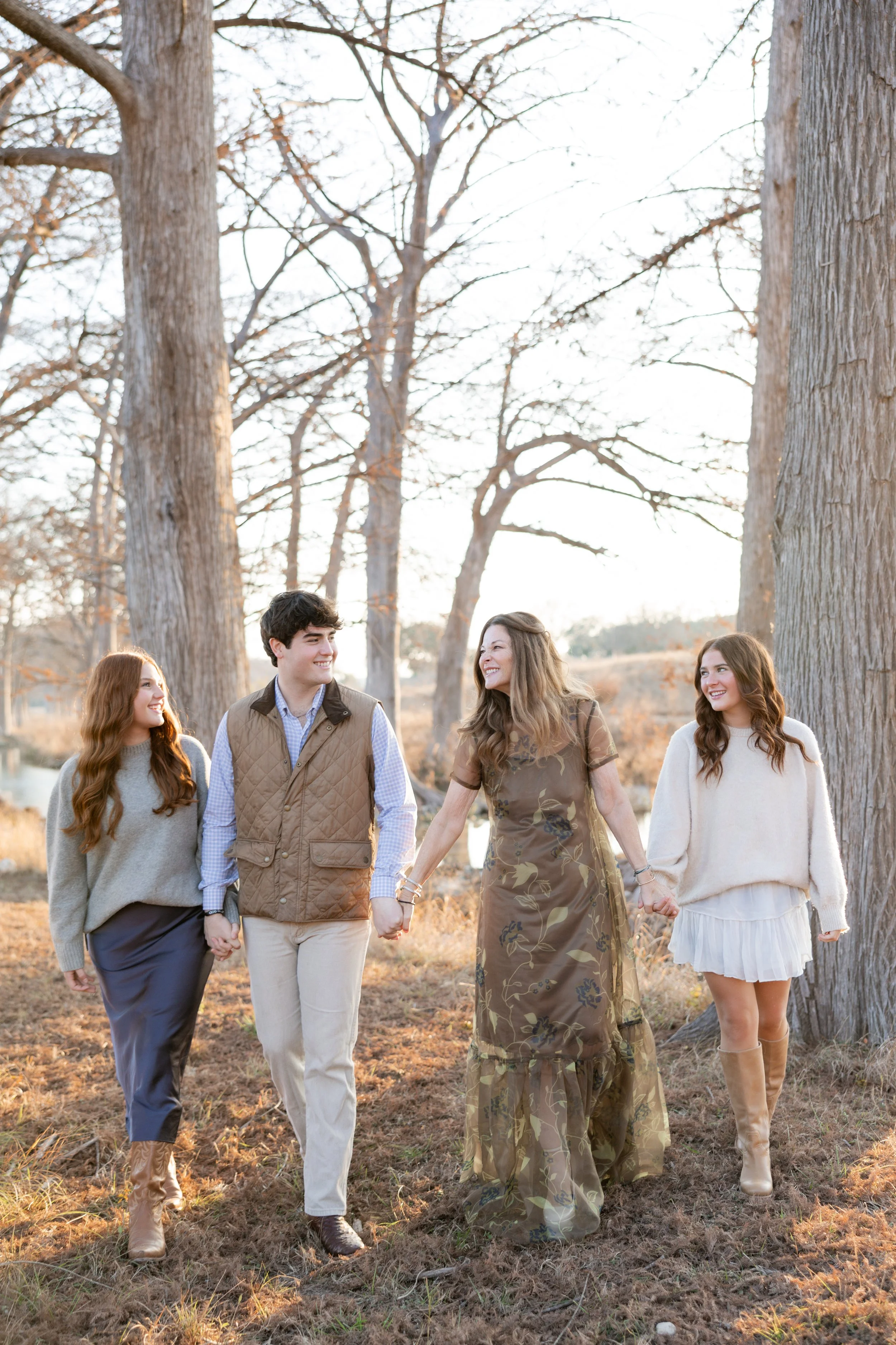 Family of four walking together during an outdoor family photography session.