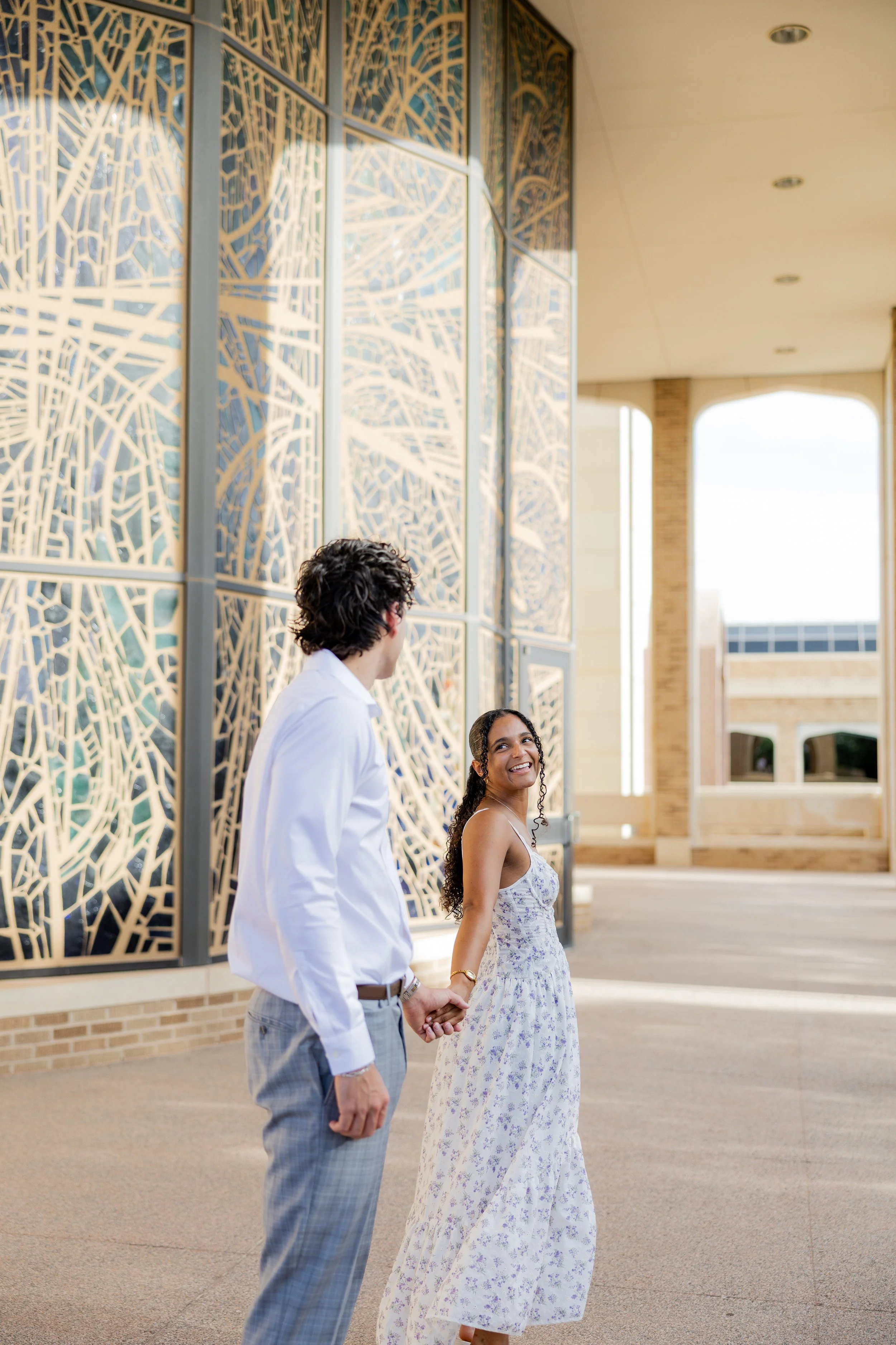 Couple holding hands and walking together during an outdoor couples photography session.