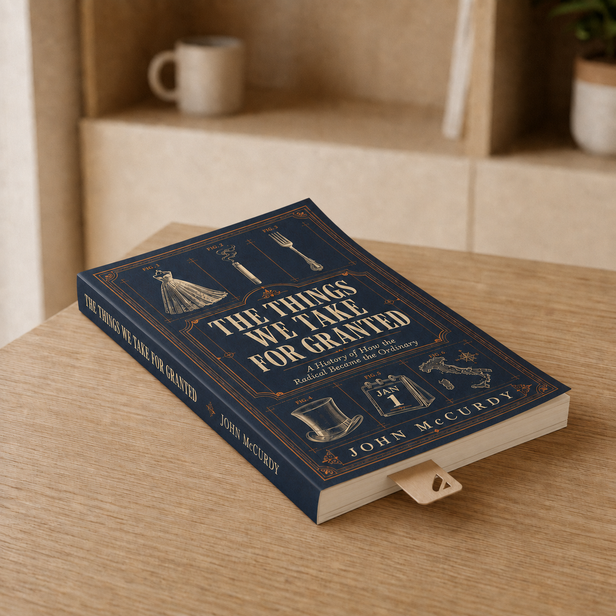 A hardcover book titled 'The Things We Take for Granted' by John McCurdy is placed on a wooden table. The cover design features illustrations of a dress, a cigarette, a fork, a top hat, a calendar showing January 1st, a map, and some other decorative elements.