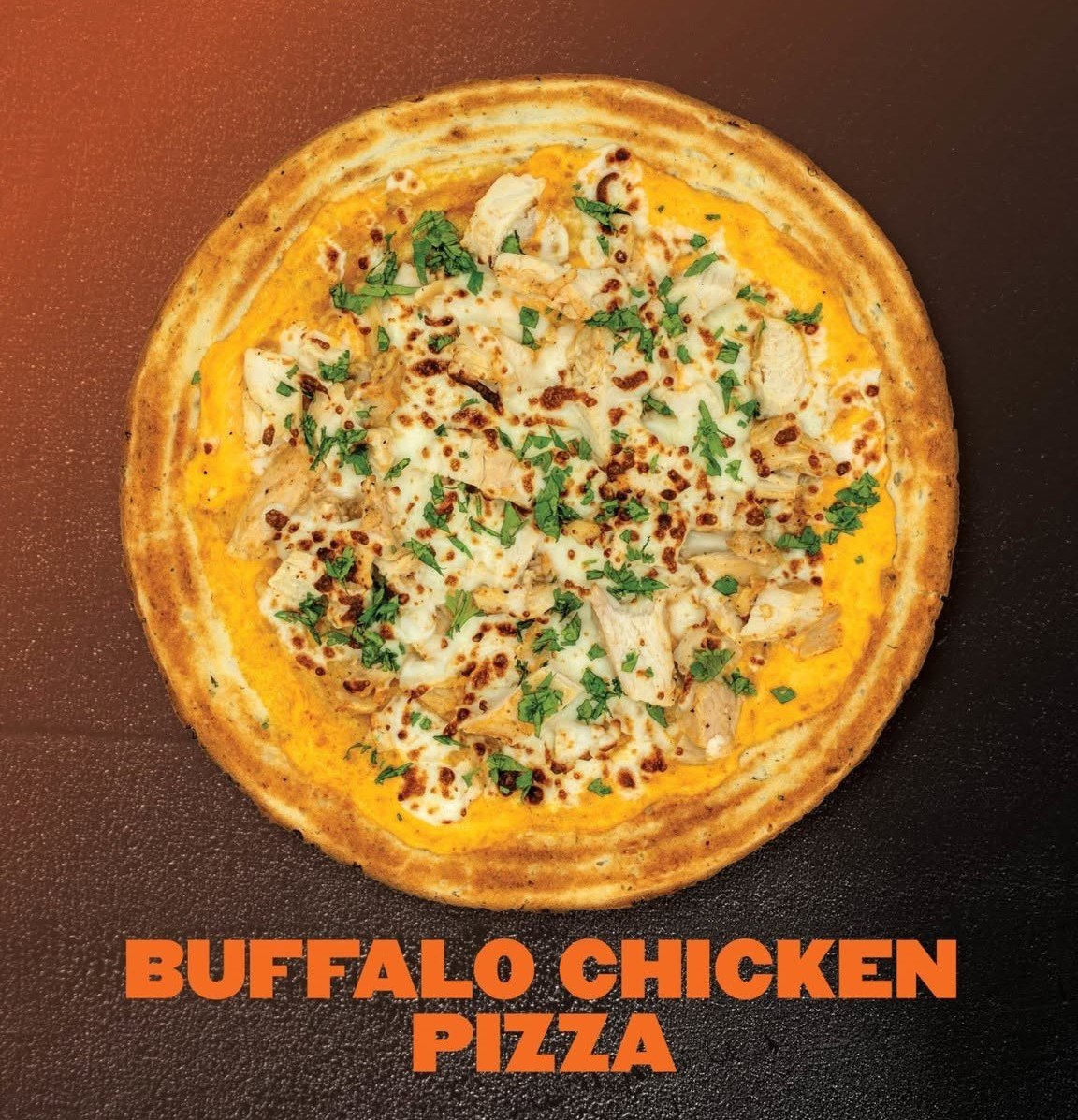 Buffalo chicken pizza topped with shredded chicken, cheese, and chopped herbs on a crust