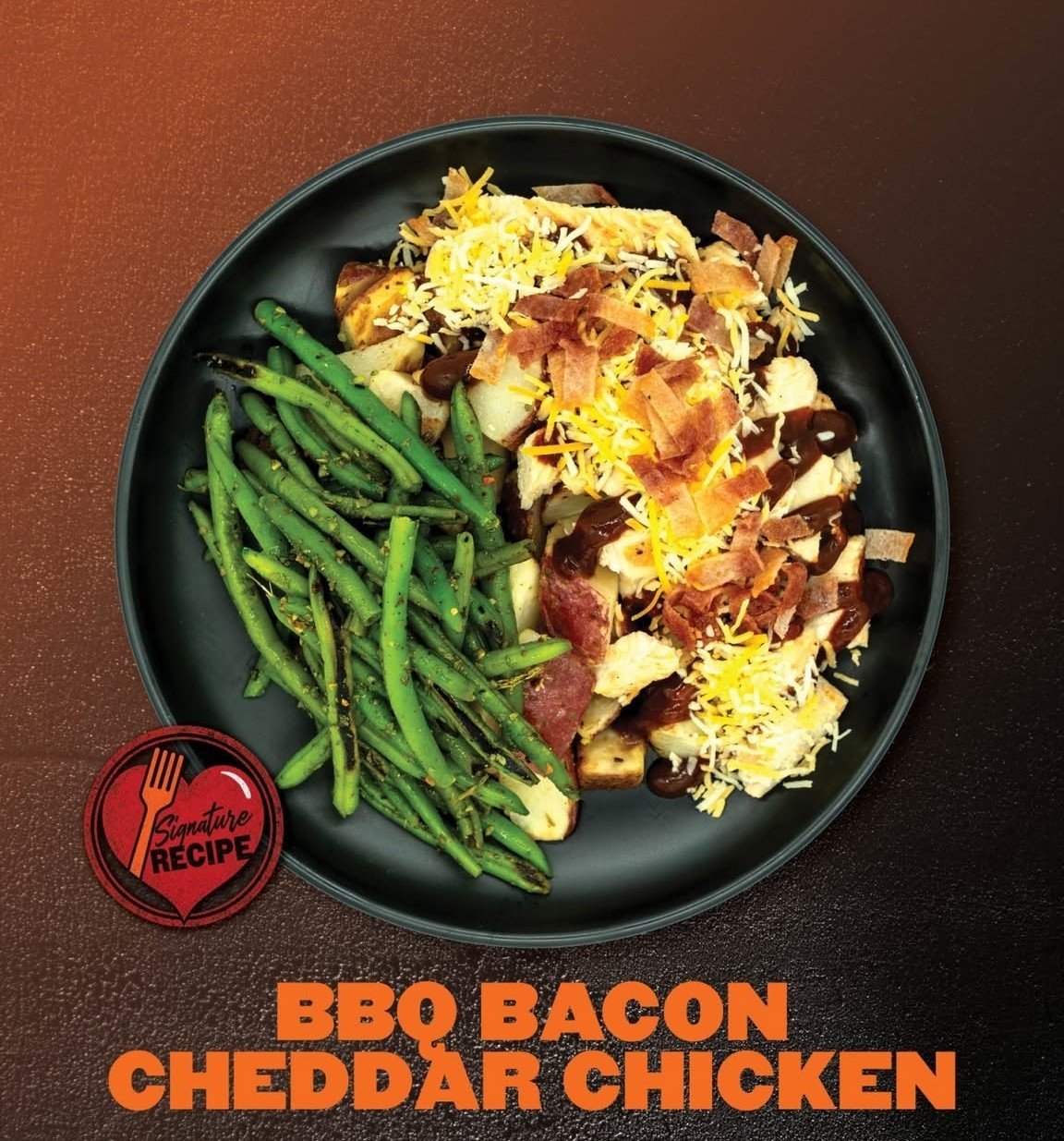 Plate of BBQ bacon cheddar chicken with green beans on a dark brown table.
