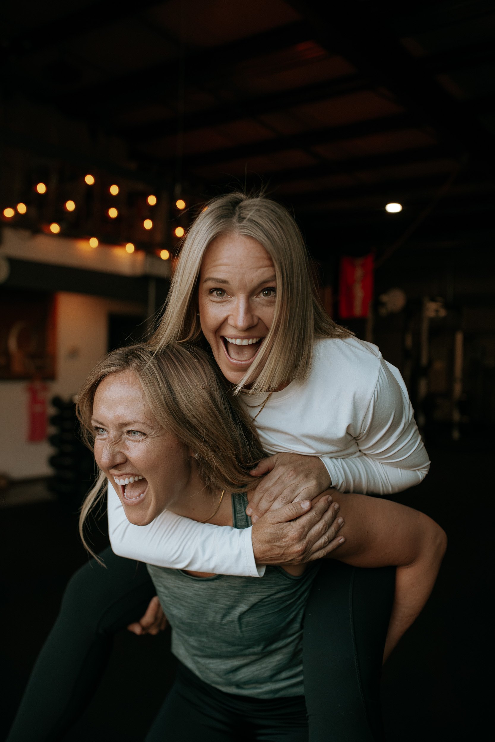 Shantell carries Lu on her back inside Dropgym.