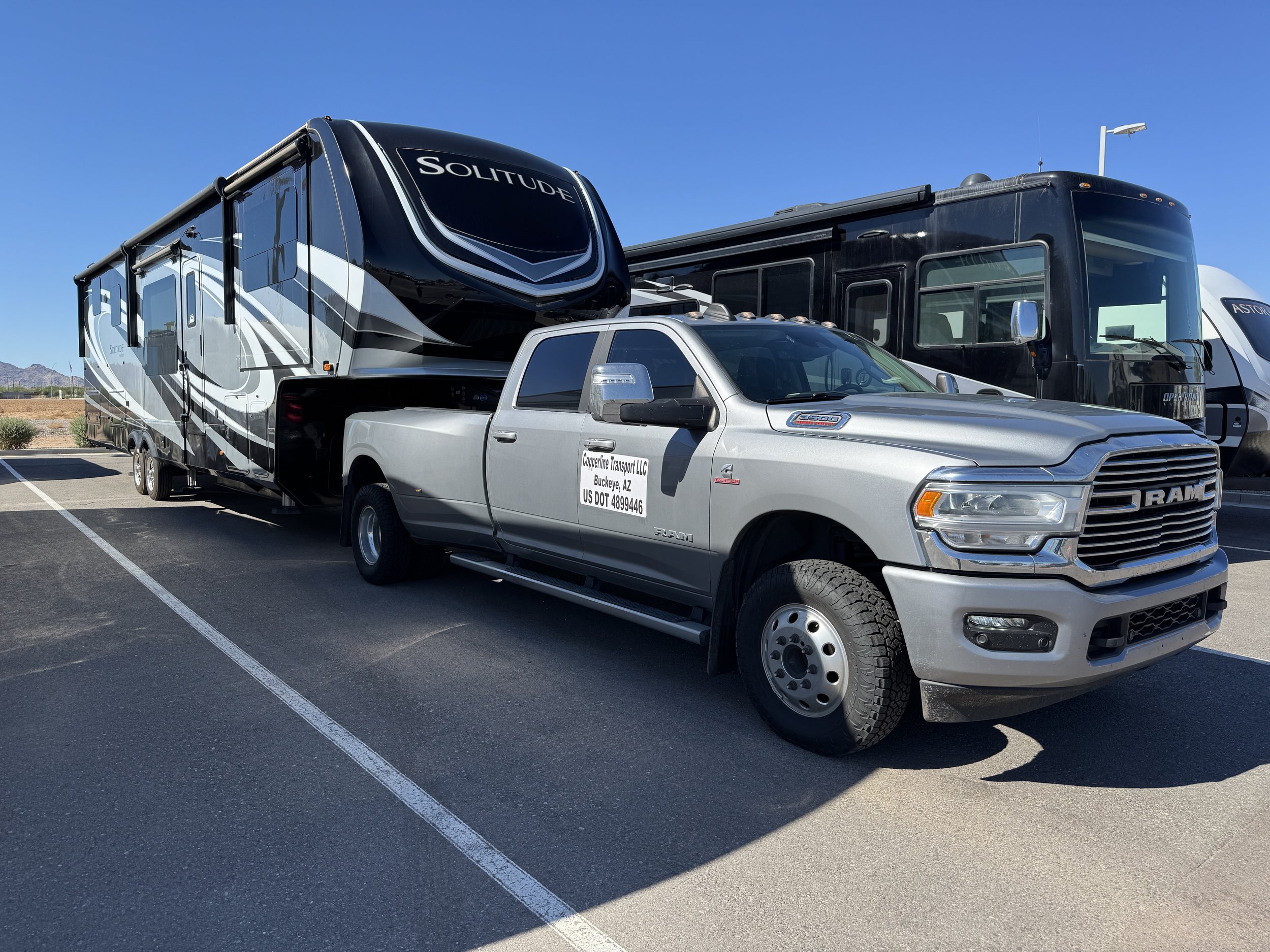 Copperline Transport Ram 3500 transporting a Grand Design Solitude Fifth Wheel RV