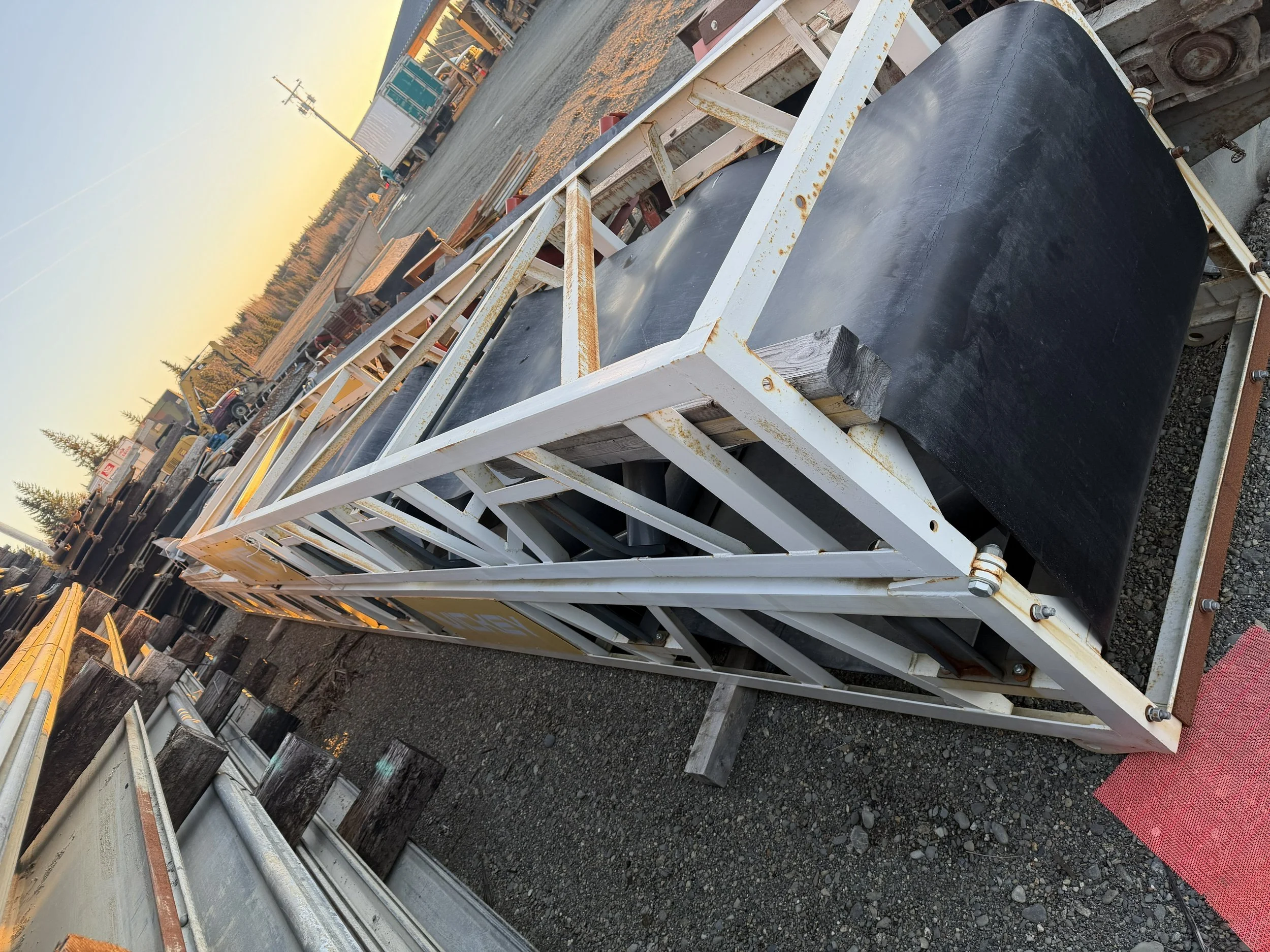 Industrial conveyor belts transporting sand at an open-pit mining site