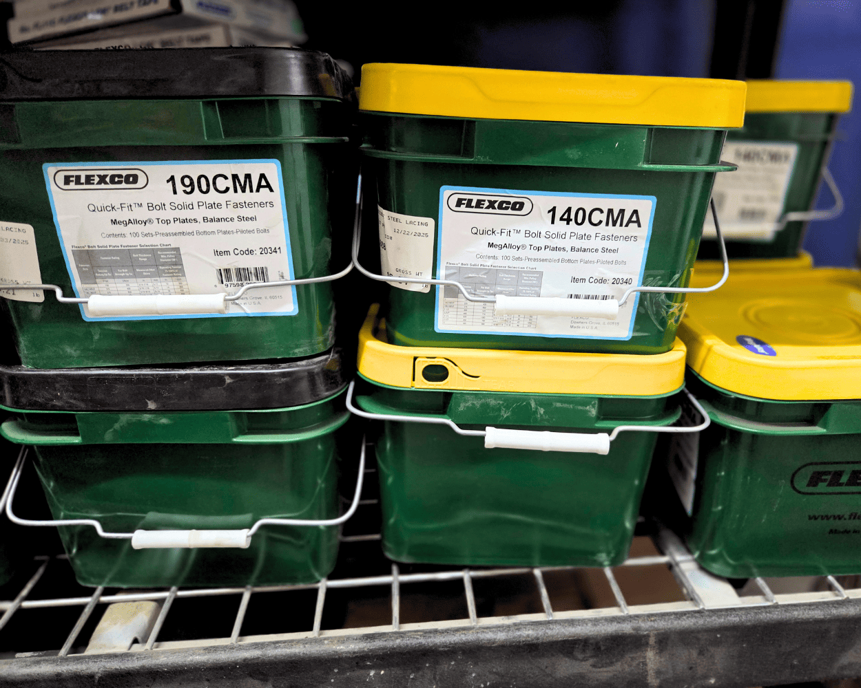 Green Flexco containers of Quick-Fit MT bolt solid plate fasteners labeled 190CMA and 140CMA on a Store shelf