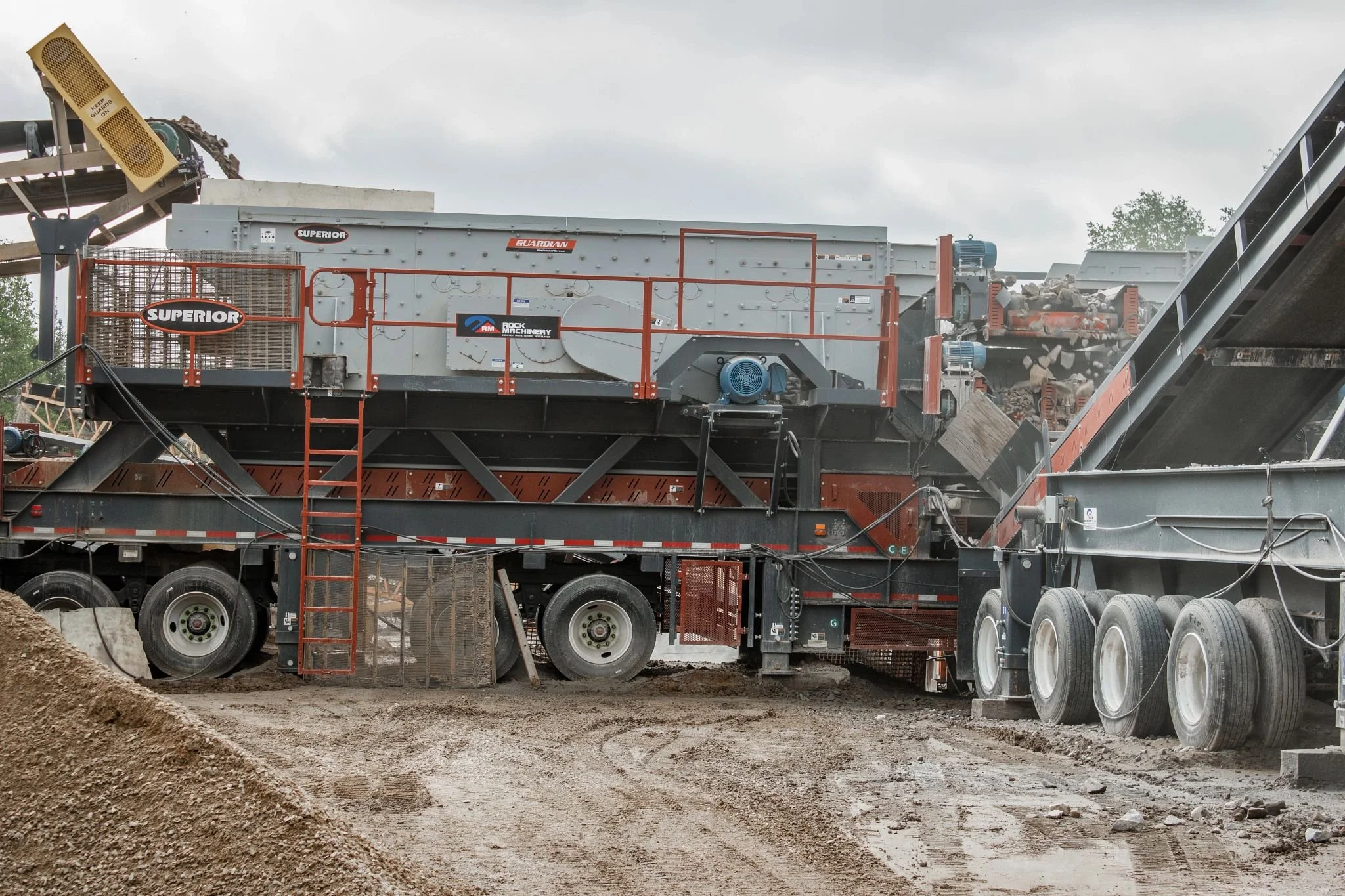 Superior Guardian mobile rock crusher and screening equipment processing crushed stone at a gravel quarry
