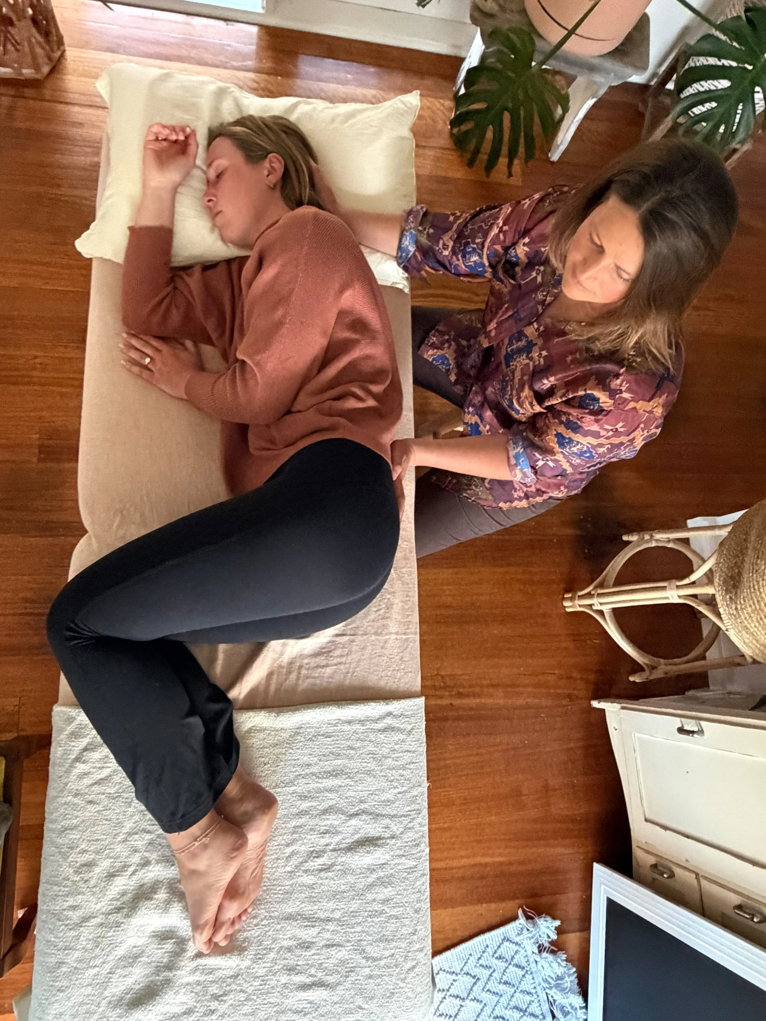 A person receiving biodynamic craniosacral therapy.