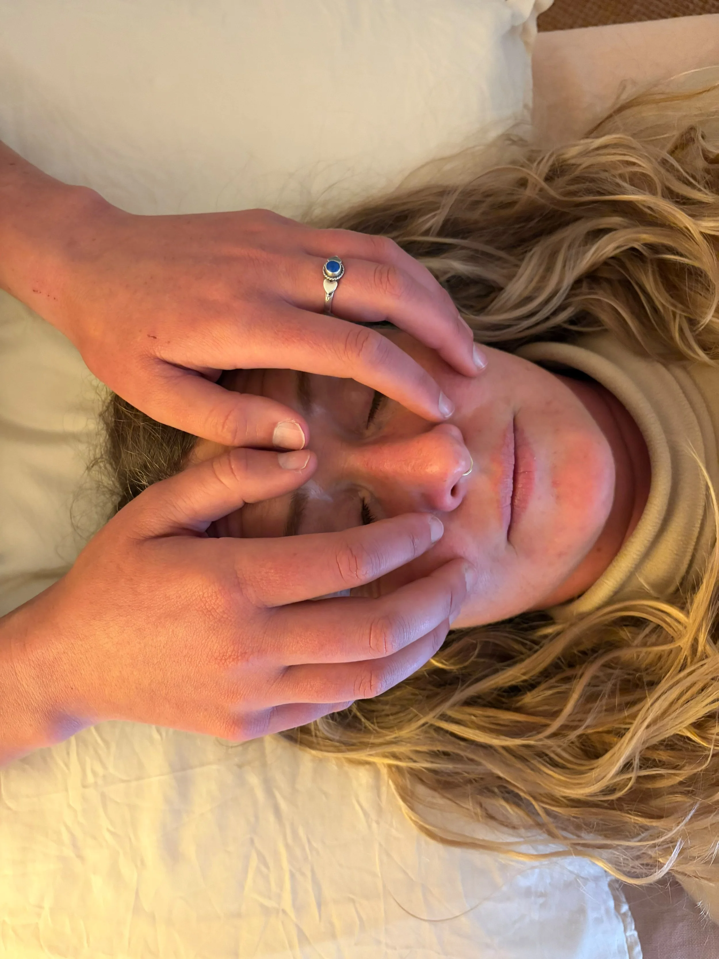A person receiving biodynamic craniosacral therapy.