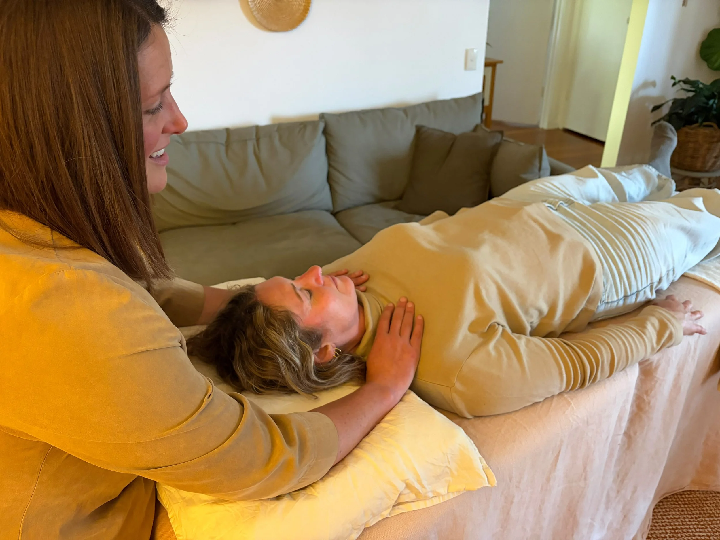A person receiving biodynamic craniosacral therapy.