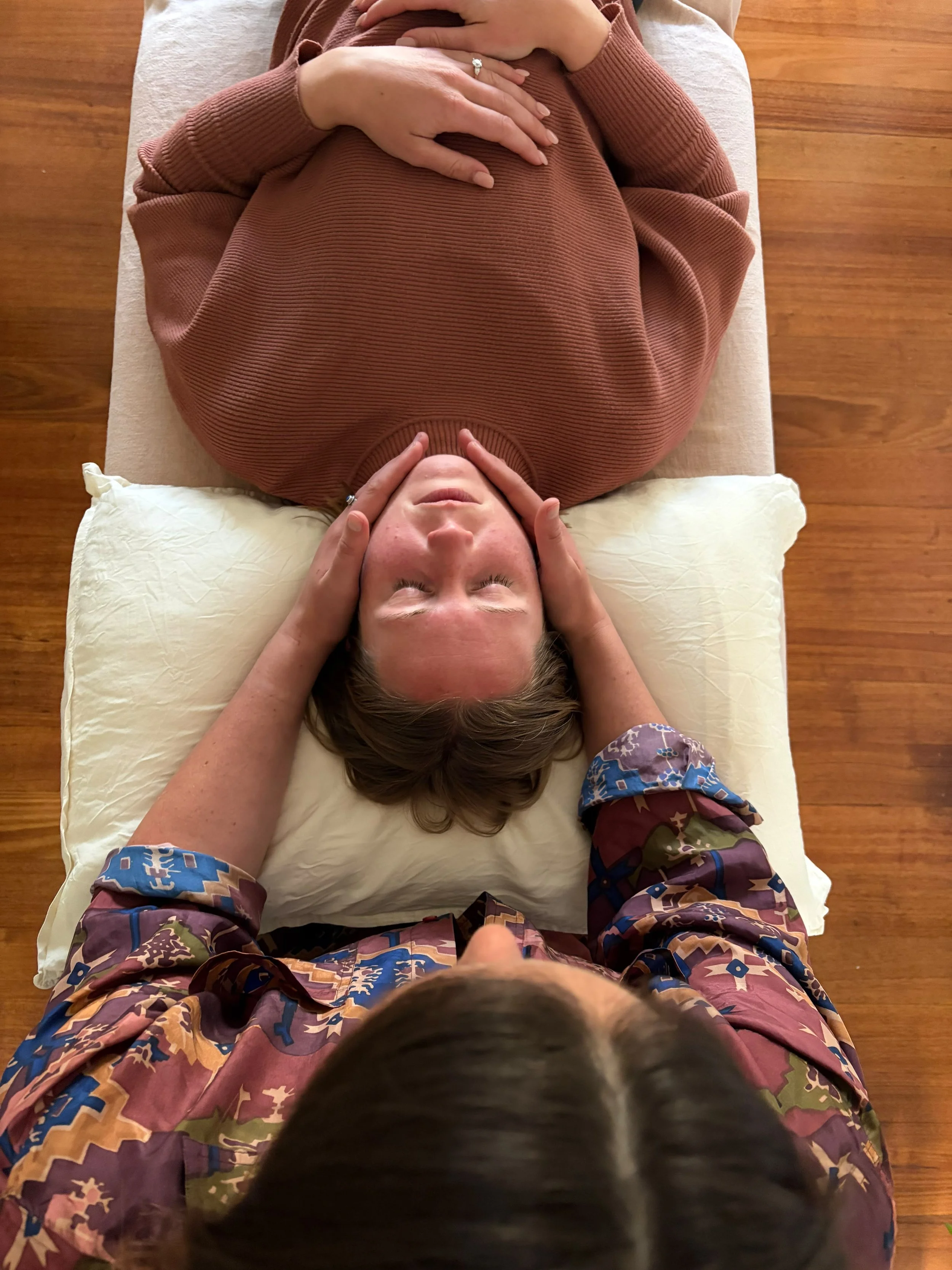 A person receiving craniosacral therapy.