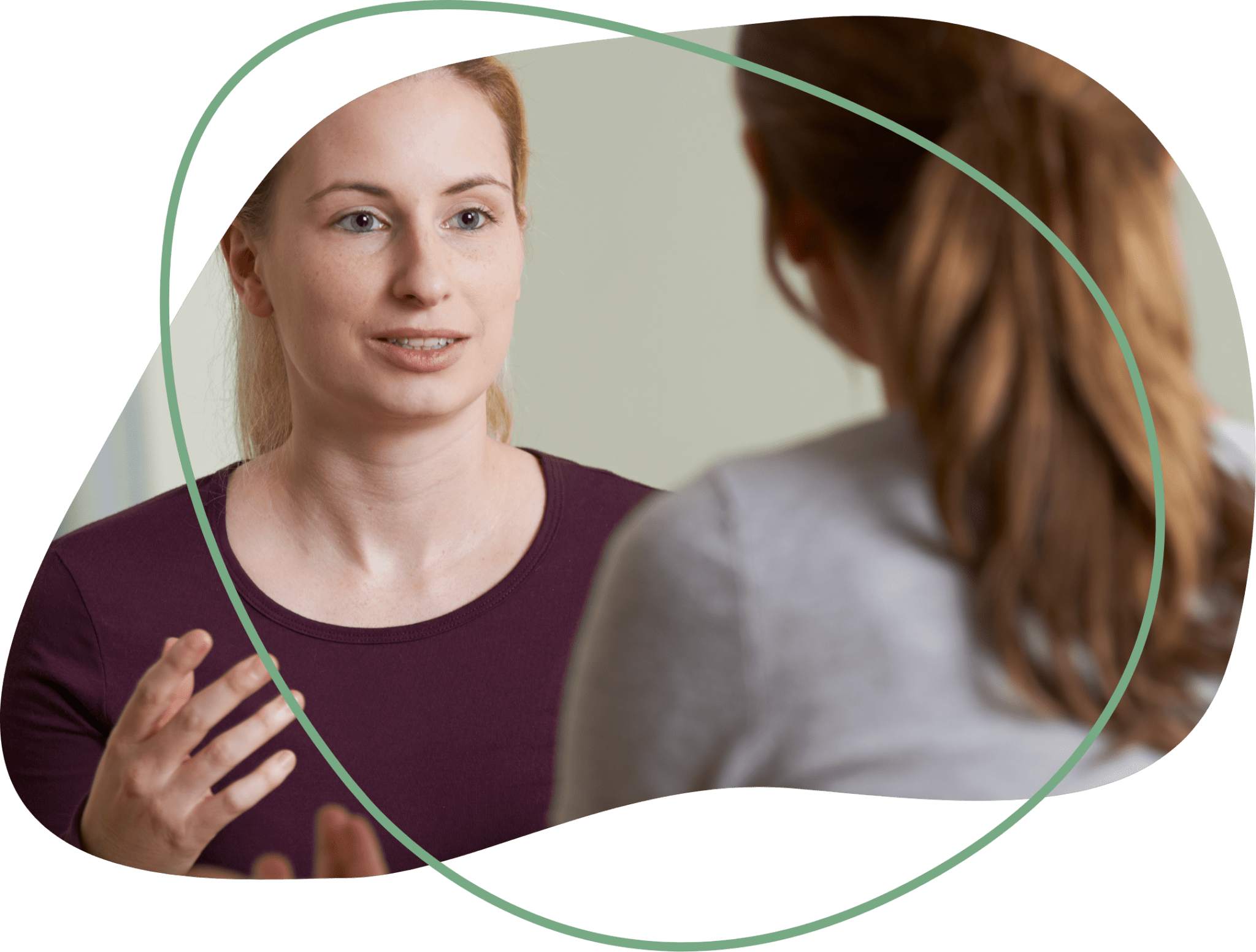 Two women engaged in conversation, one facing the camera with a serious expression, the other with her back to the camera, with highlighted hair. The scene is framed with abstract green curved lines.