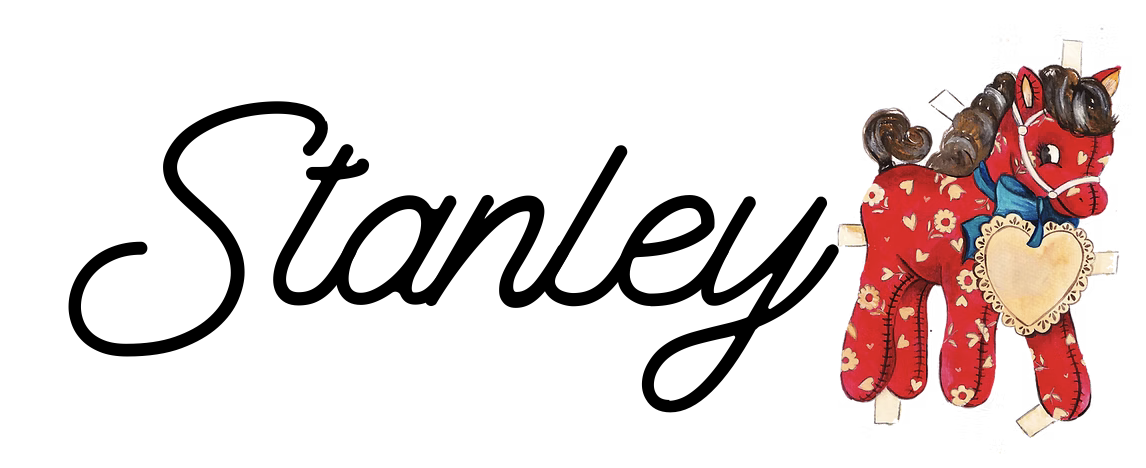 The image features the name 'Stanley' written in black cursive font and a plush red horse with a heart-shaped patch on its chest, adorned with a blue bow around its neck.