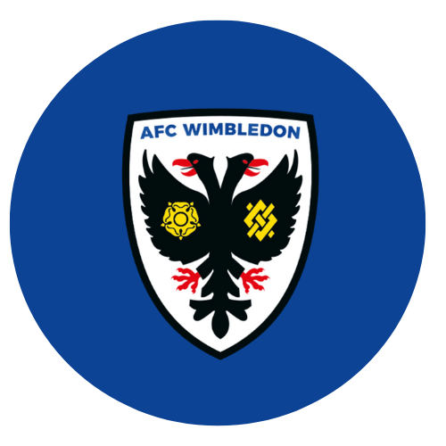 The AFC Wimbledon logo featuring a black eagle with red beak and claws, and two yellow symbols on its wings, within a white shield that has a blue border and the text "AFC Wimbledon" at the top, on a blue background.