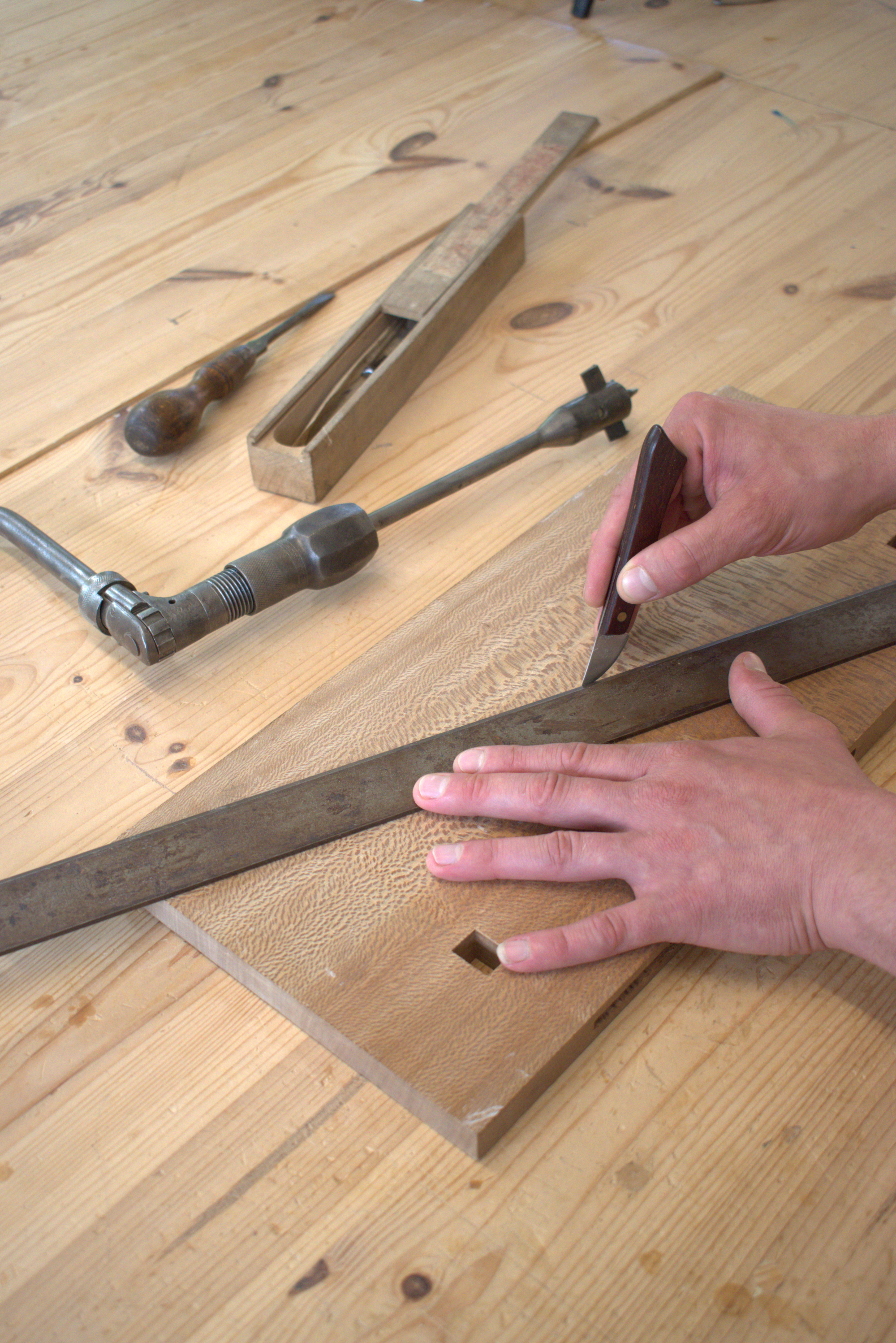 Oxford based furniture maker scibing a straight line on timber for bespoke furniture.