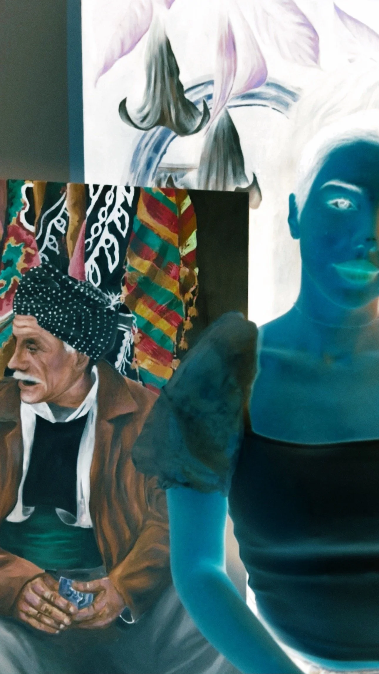 Artist Soniya beside her negative portrait painting, created in inverted colours and designed to reveal its true colours when viewed through a negative filter.