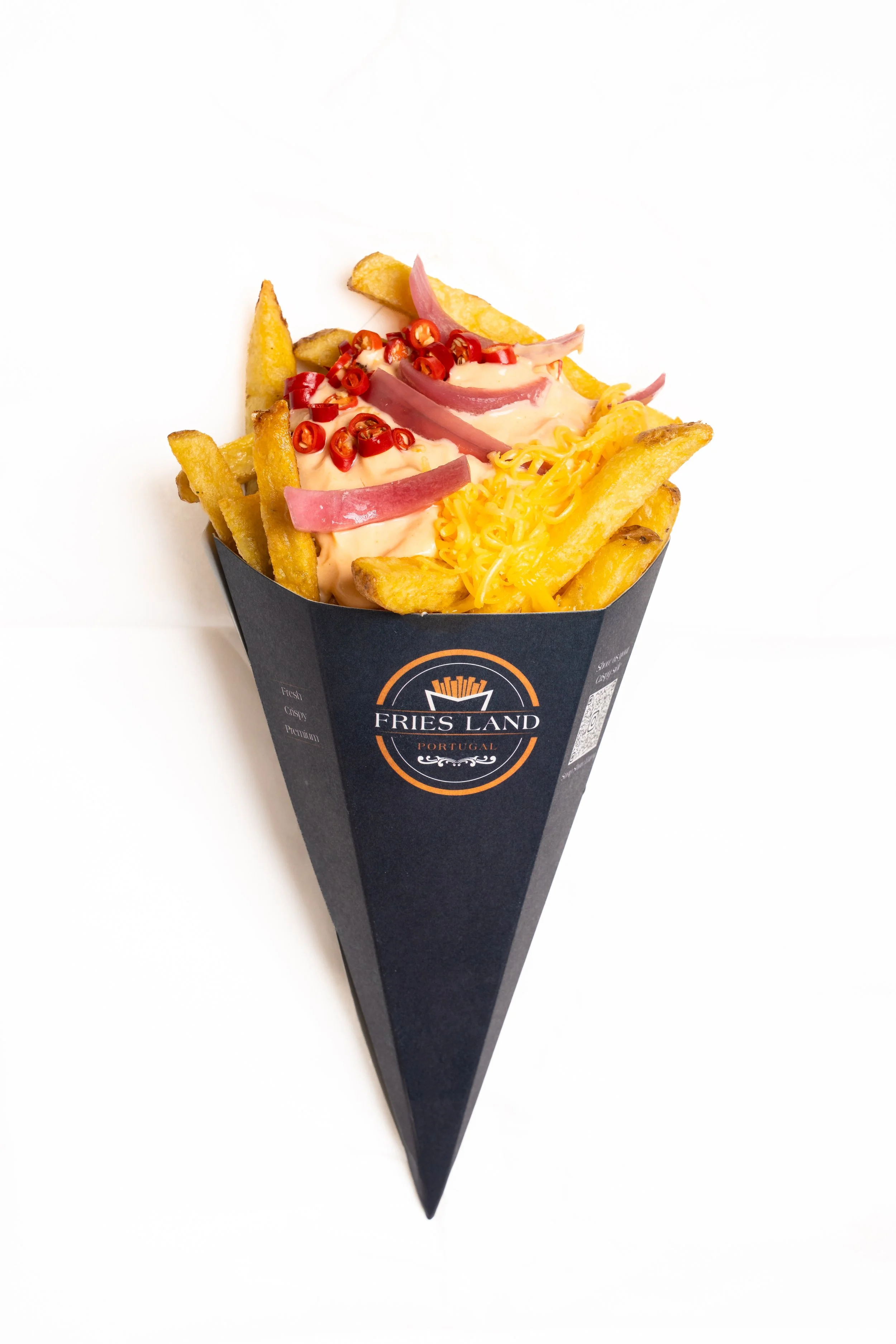 A black container of French fries topped with cheese, red chili slices, sliced red onions, and a creamy sauce from Fries Land Portugal.