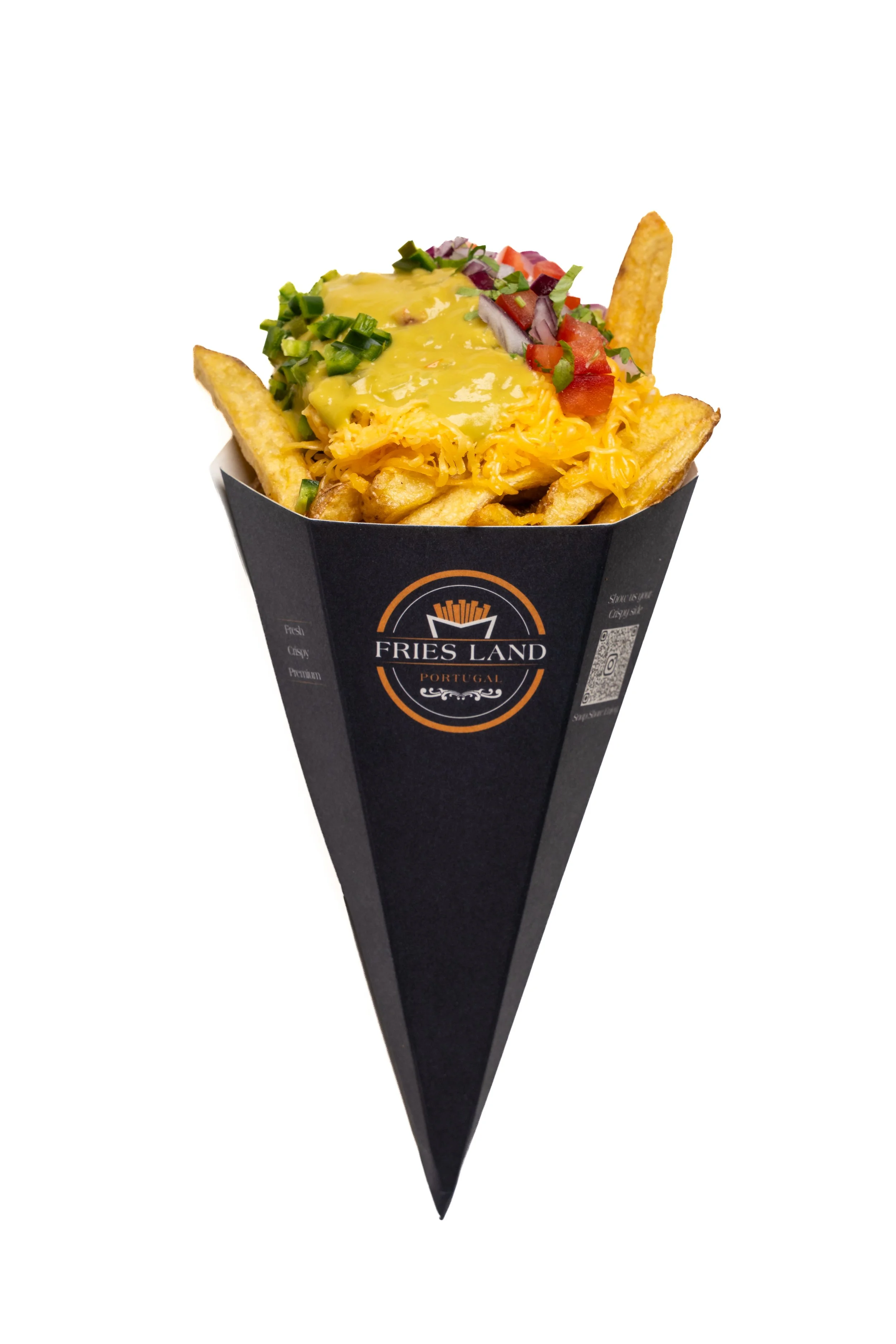 A paper cup from Fries Land Portugal filled with French fries topped with cheese, chopped green onions, diced tomatoes, red onions, and garnished with a slice of potato chip.