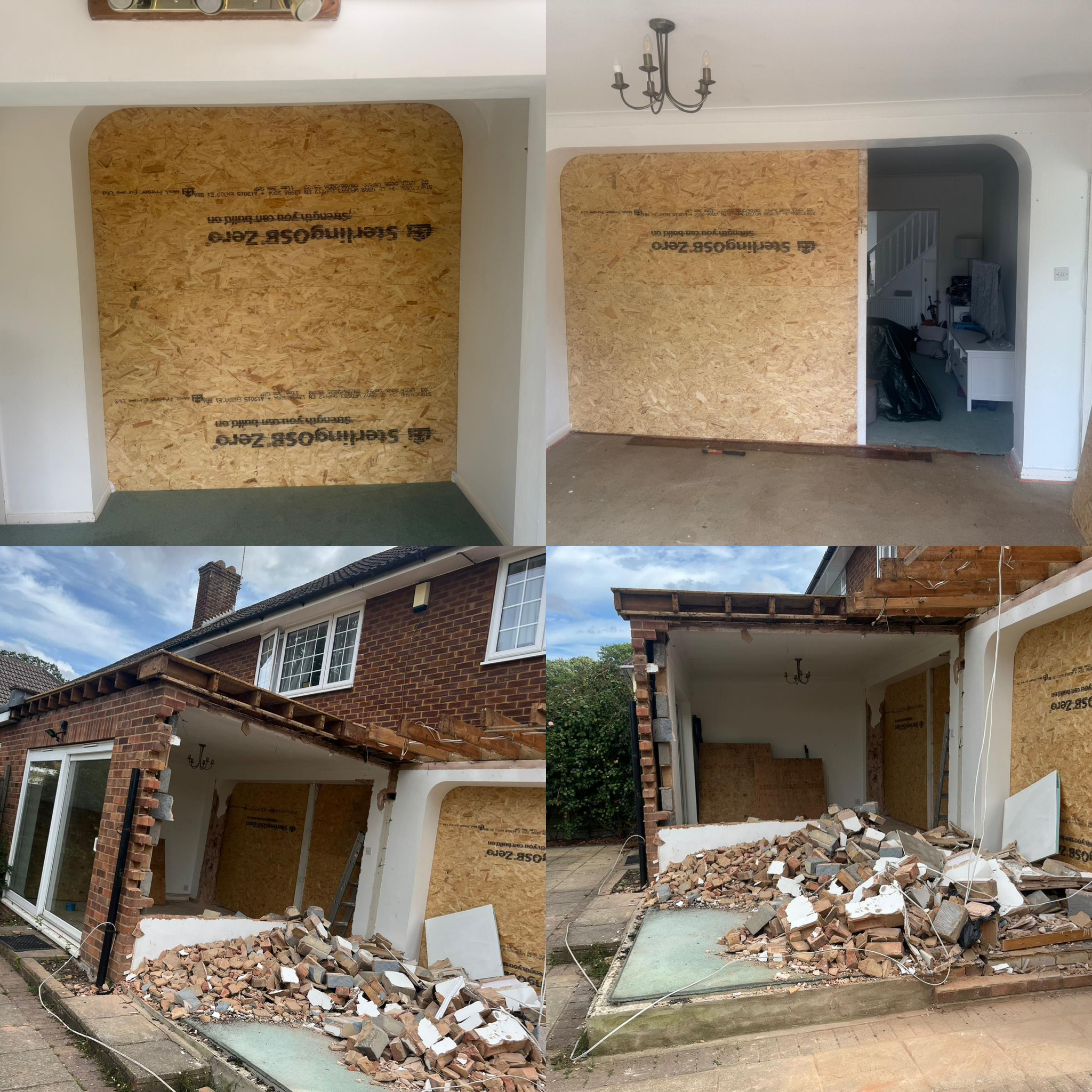 Photo showing a house renovation with a large plywood wall, construction debris, and an unfinished brick patio area.