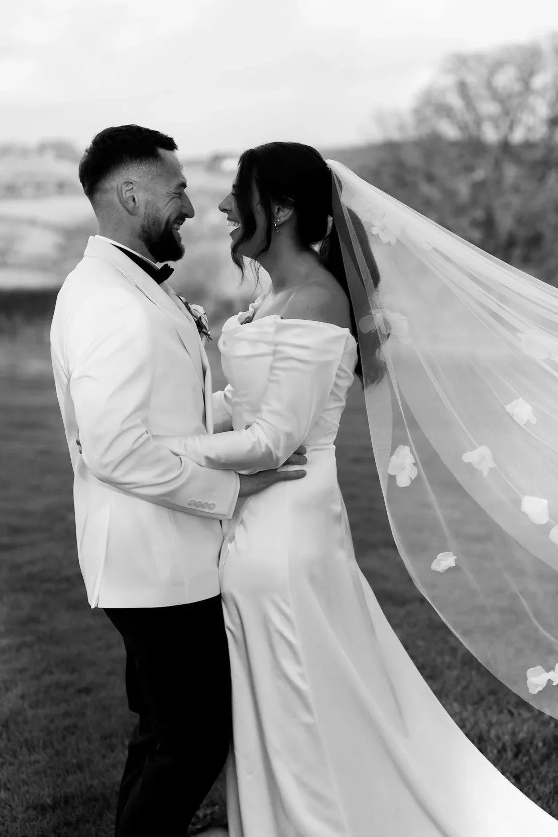 Laurie’s customers, Fernando and Kate embracing by the lake on their wedding day.