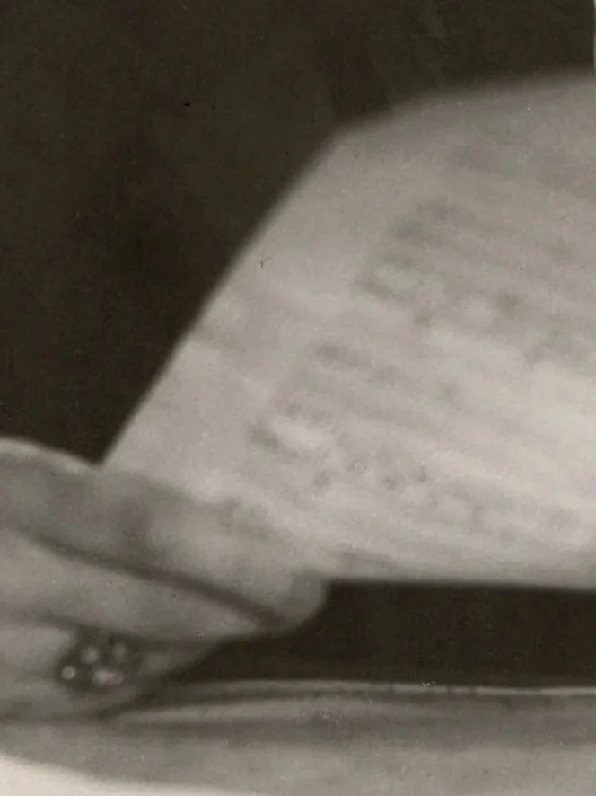 Close-up of a textured surface with printed text, partially obscured and blurry.