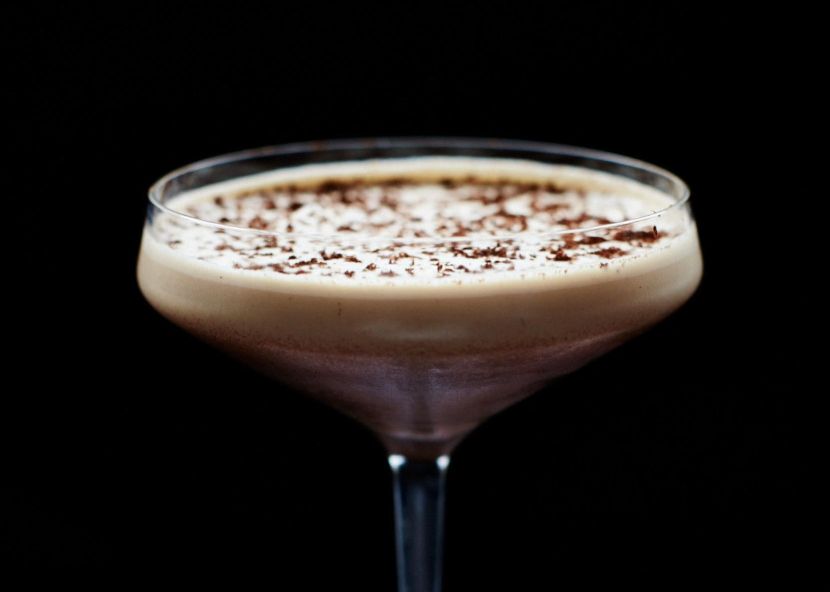 A signature Espresso Martini cocktail in a vintage coupe glass.