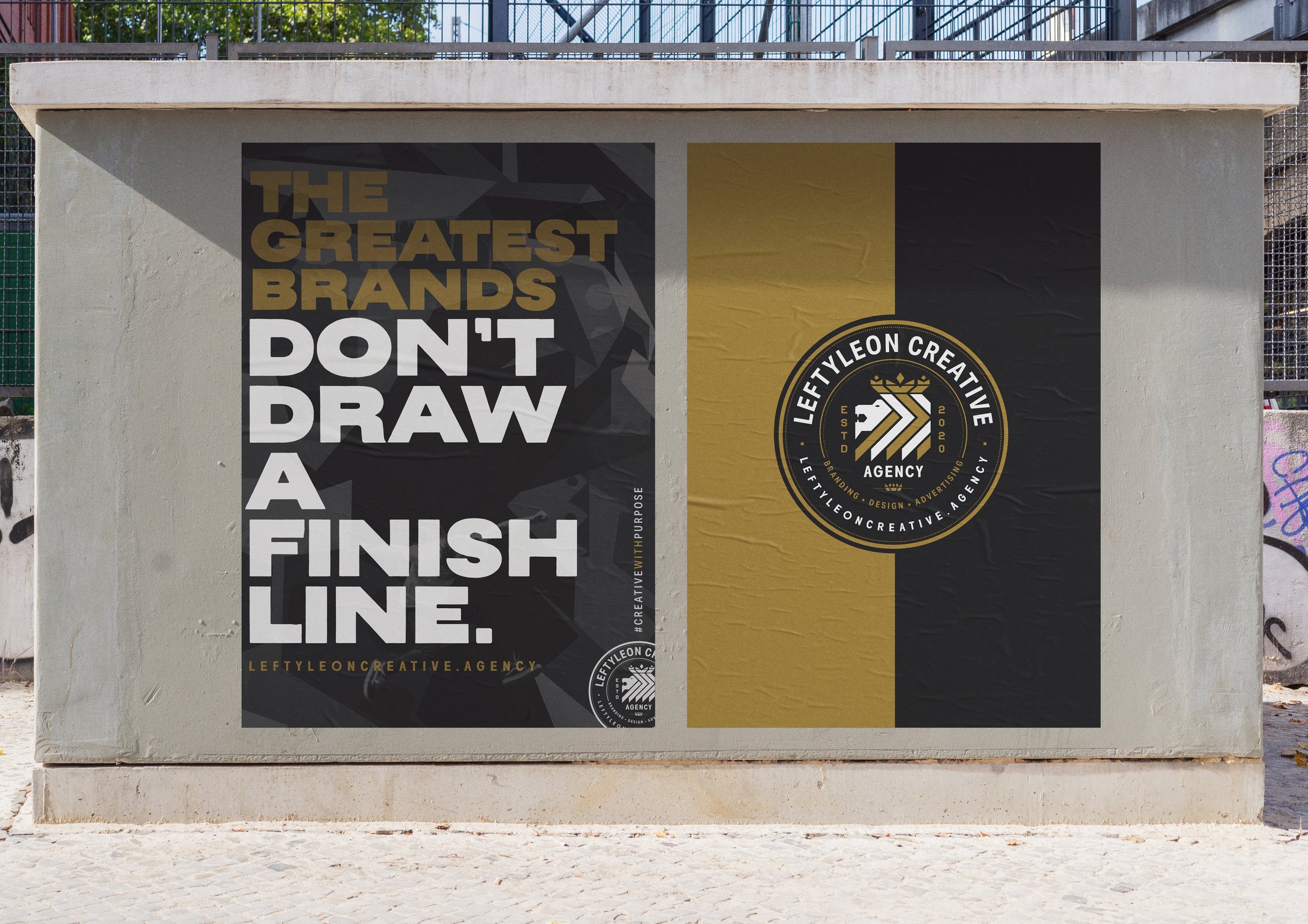 Street art banners on a concrete wall, one promoting a creative agency called Lefty Leon Creative Agency with a circular logo and the text stating 'The greatest brands don't draw a line,' and the other with large bold letters and a motivational messa