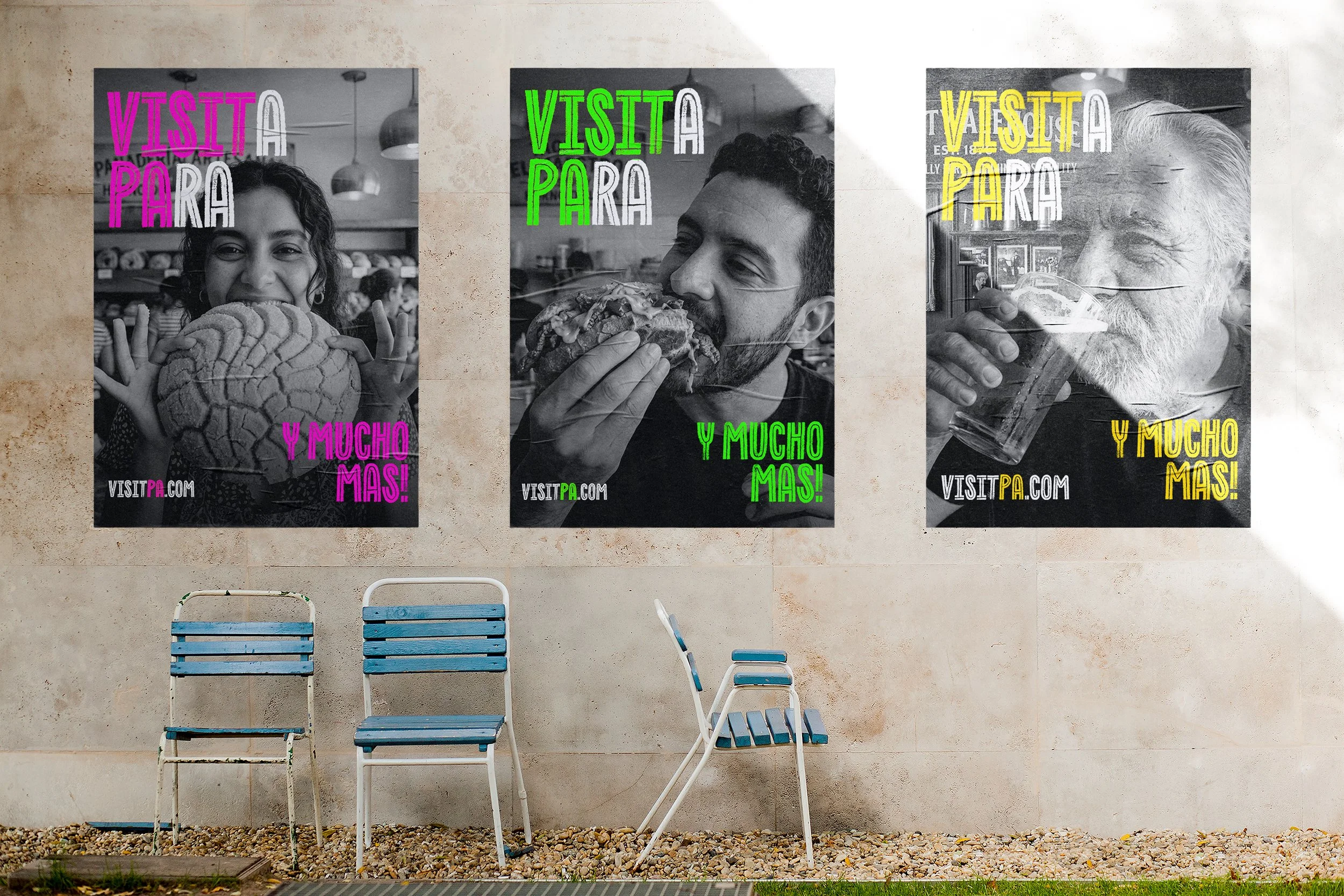 Three black-and-white posters on a light-colored wall, each showing a person enjoying food with colorful text overlaid. The first poster has a woman smiling and holding a large bread, with pink text reading 'VISTA PARA' and purple text 'Y MUCHO MAS!'
