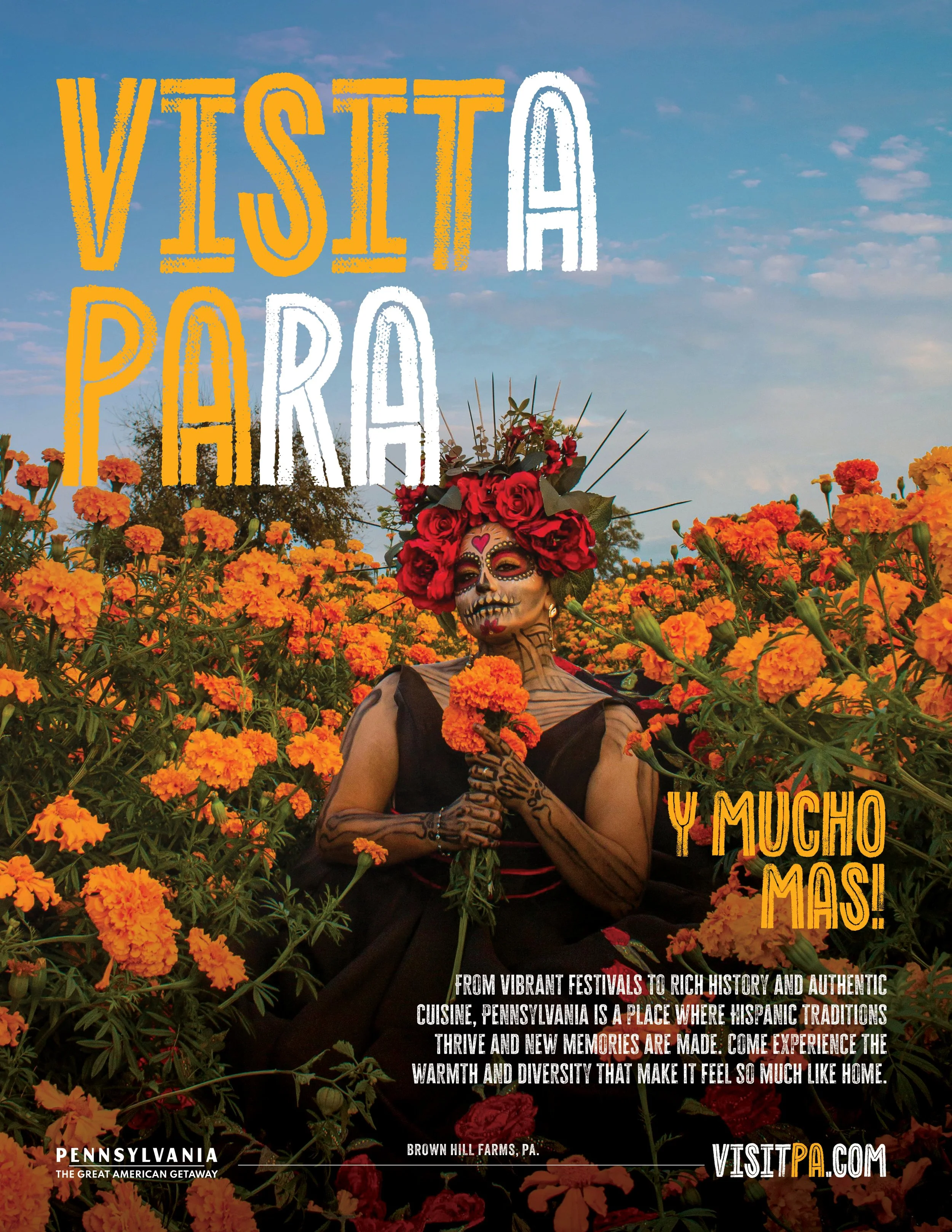 A festive scene featuring a person with sugar skull makeup and a floral headdress standing amid bright orange marigold flowers with a blue sky background. Text overlays promote visiting Pennsylvania, emphasizing its vibrant festivals, rich history, a