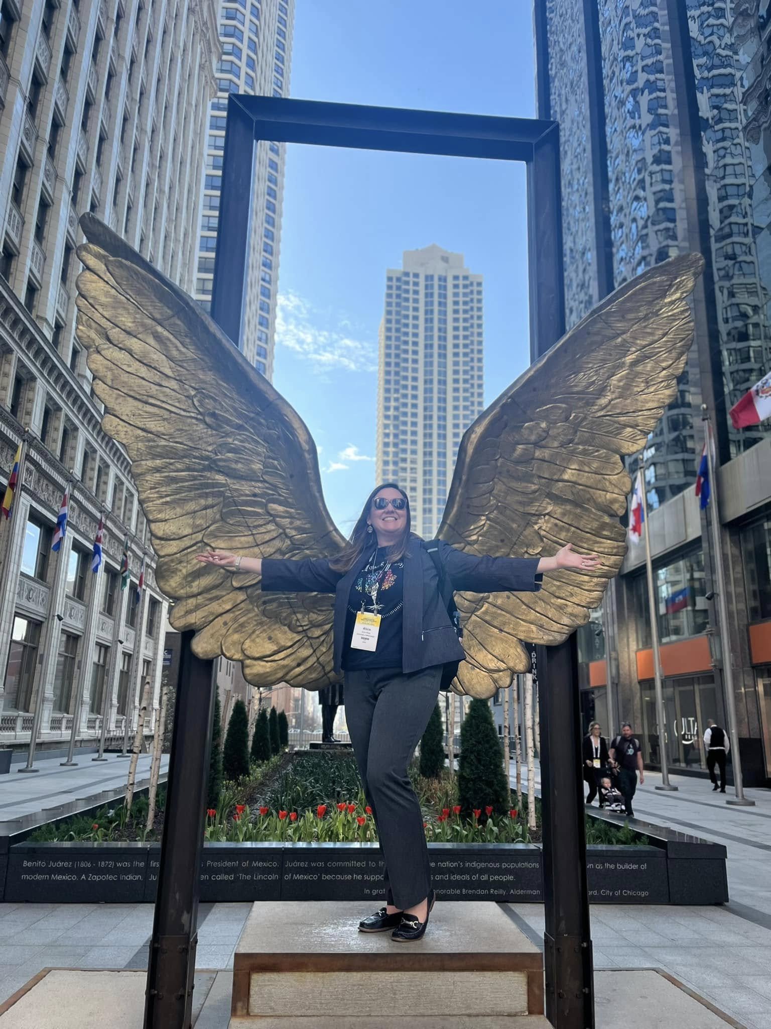 Alicia Stapp in front of wings statue